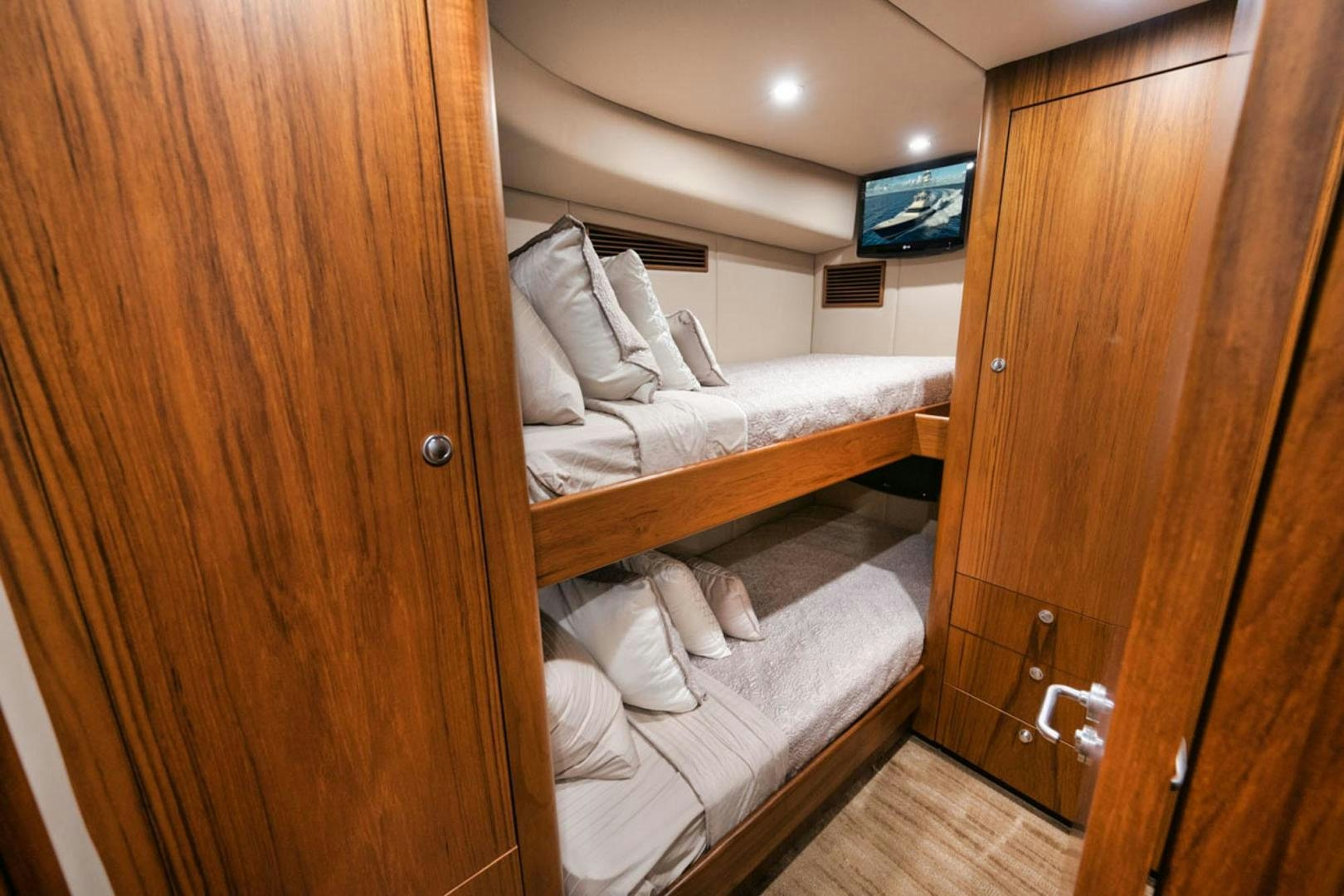 a room with a bed and a television aboard SIR REEL Yacht for Sale