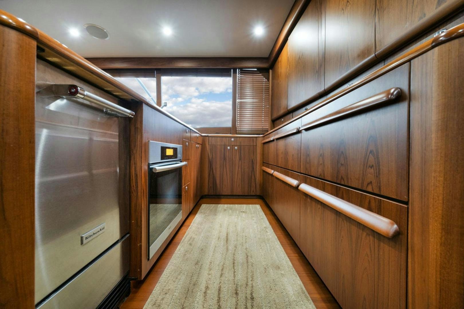 a room with wooden cabinets and a wood floor aboard SIR REEL Yacht for Sale