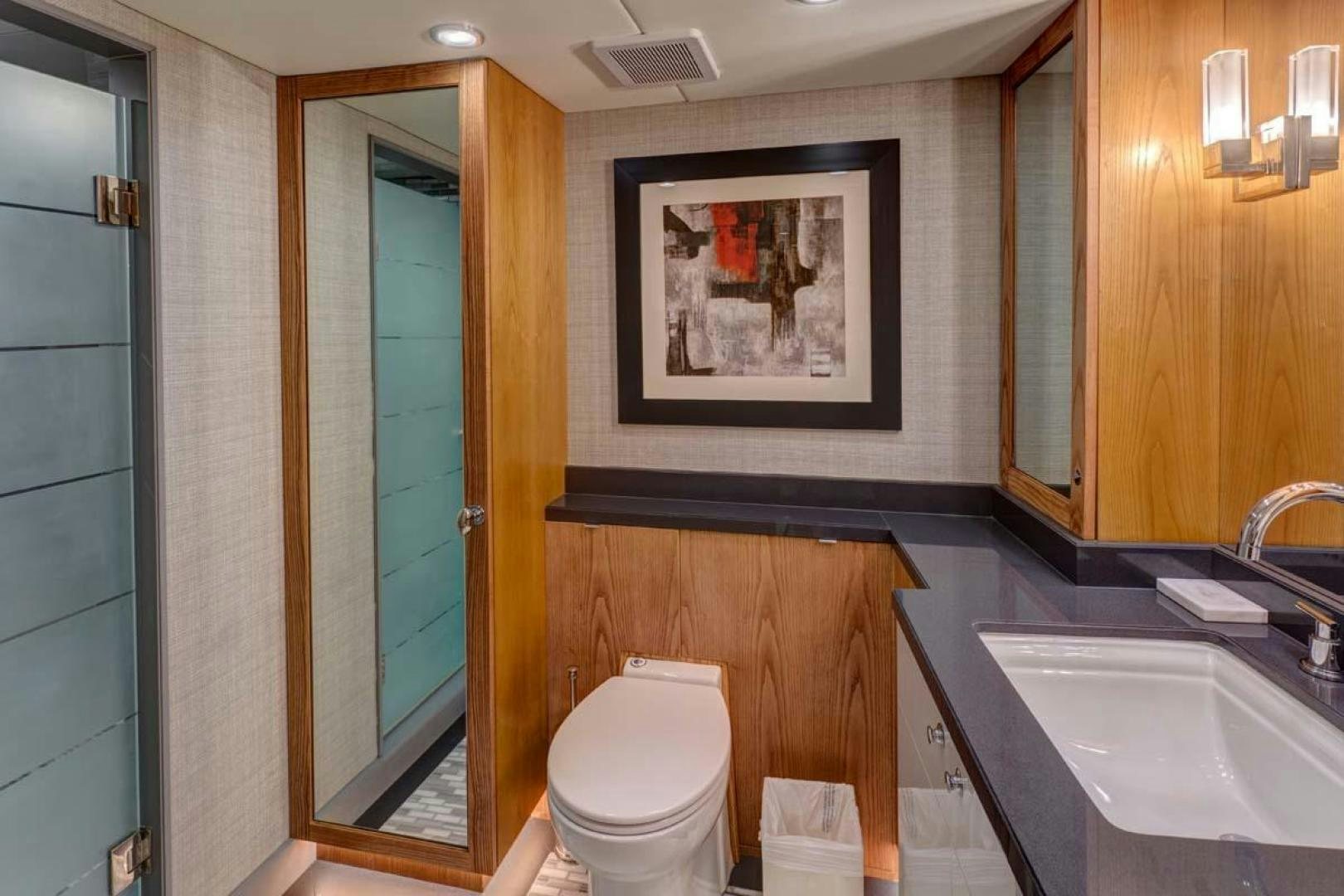 a bathroom with a toilet sink and a mirror aboard MARGATE Yacht for Charter