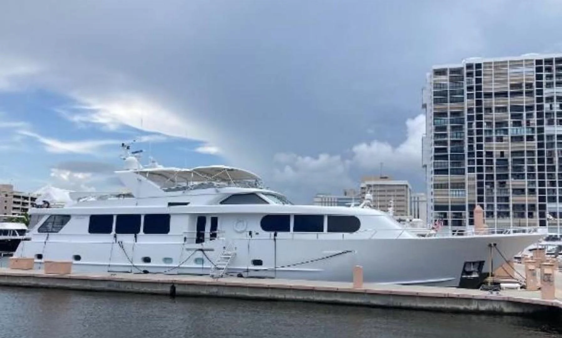 a white boat in a harbor aboard MY LADY ALASKA Yacht for Sale