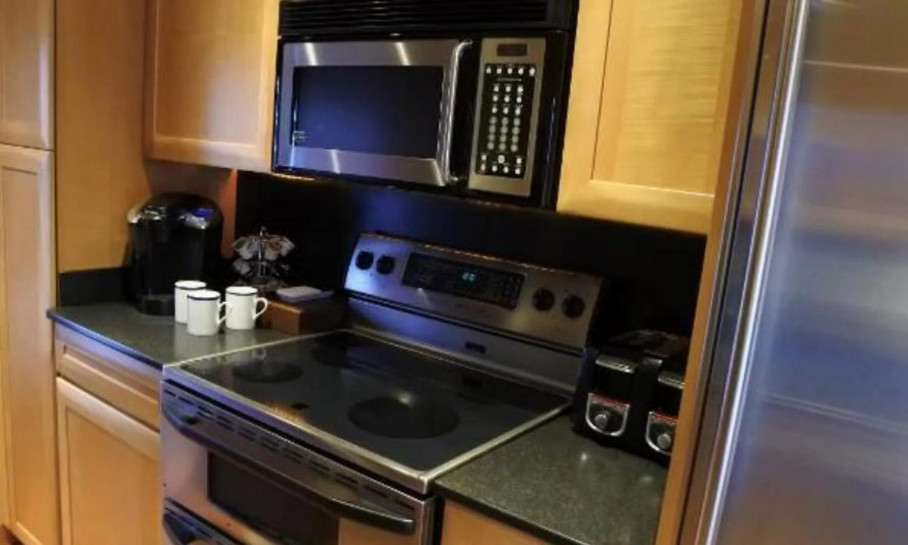 a kitchen with a microwave oven and coffee maker aboard MY LADY ALASKA Yacht for Sale