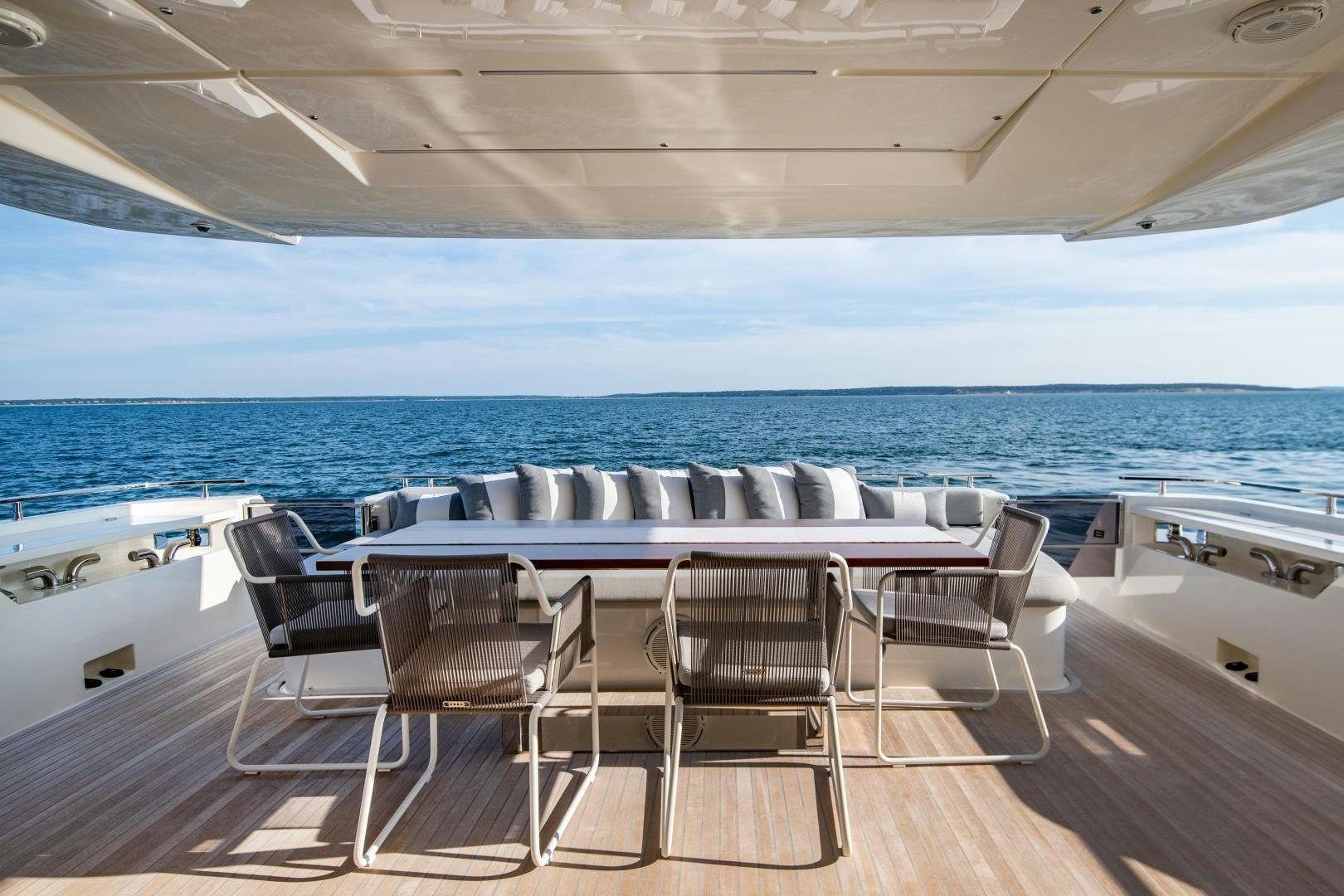 a room with a table and chairs on a deck aboard FERRETTI 850 Yacht for Sale
