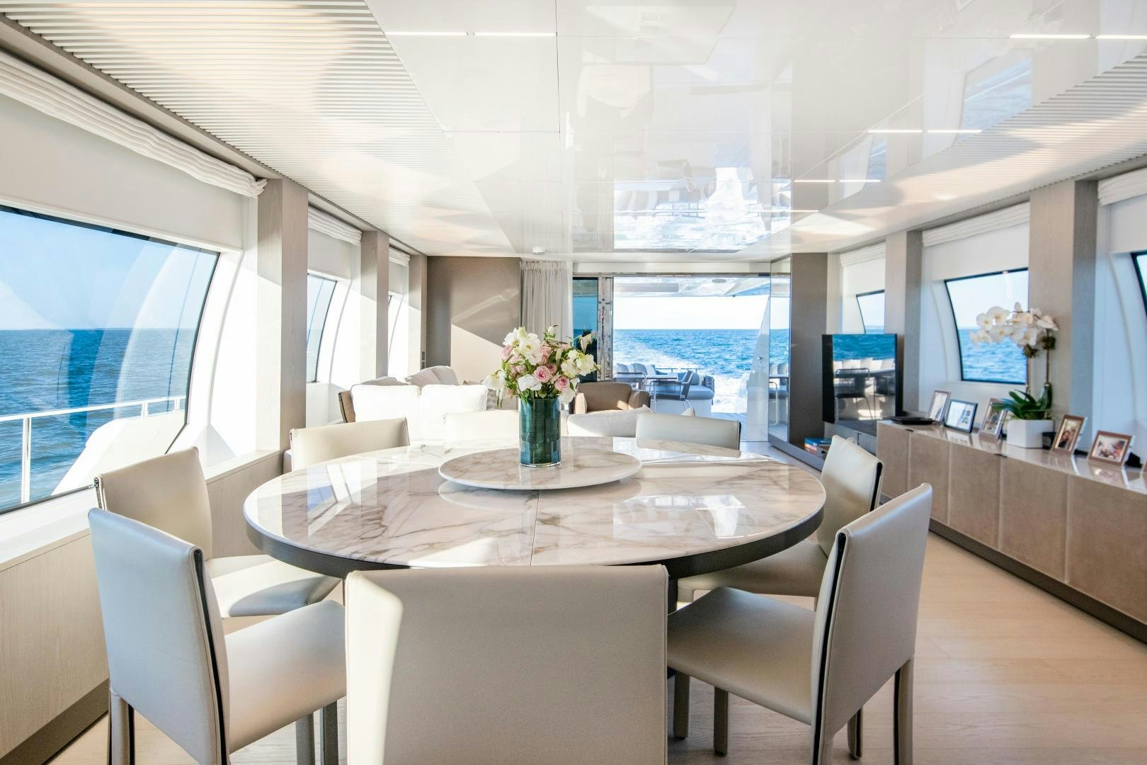 a room with a table chairs and a window aboard FERRETTI 850 Yacht for Sale