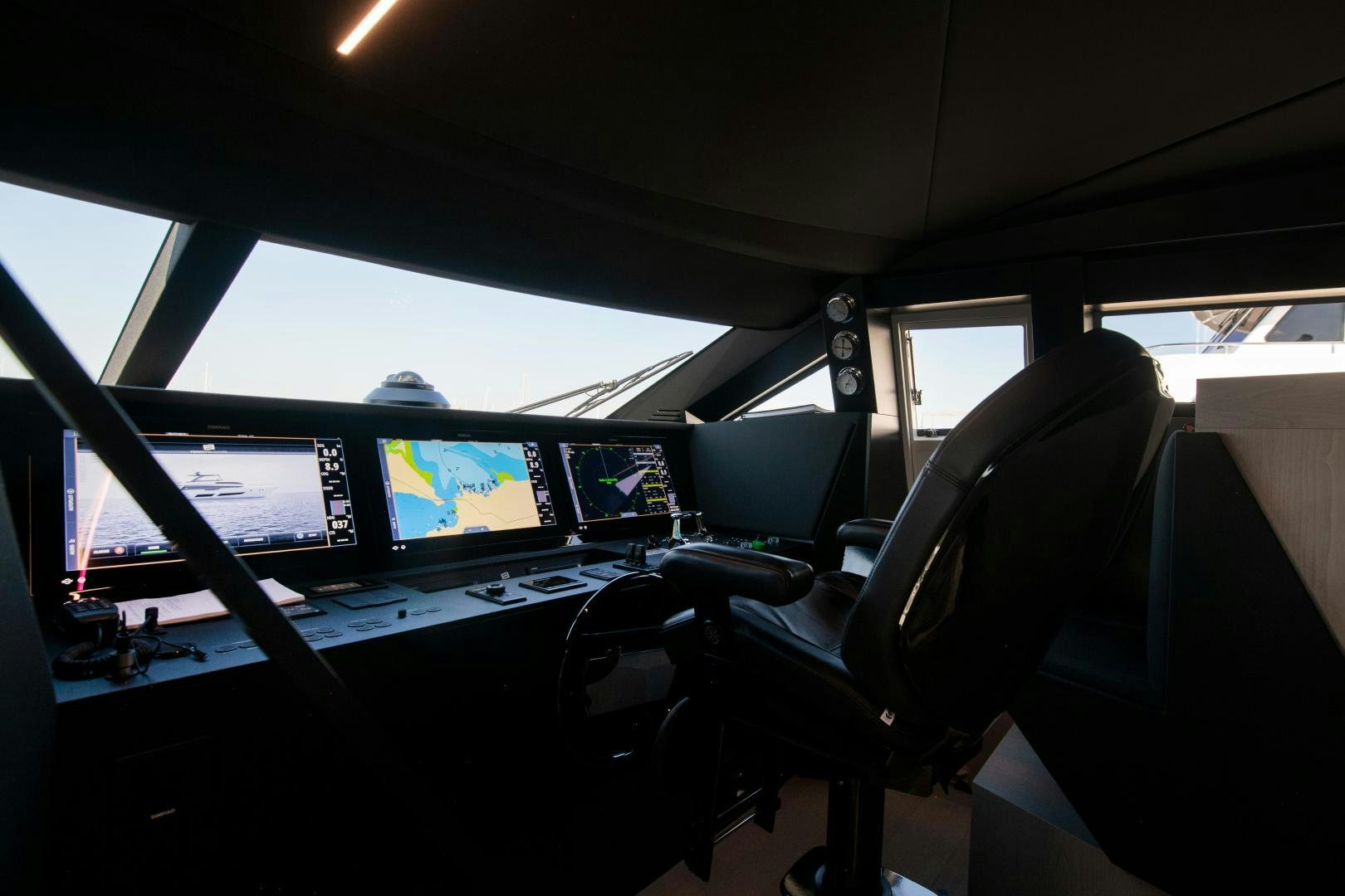 a view of a control room with many monitors and seats aboard FERRETTI 850 Yacht for Sale