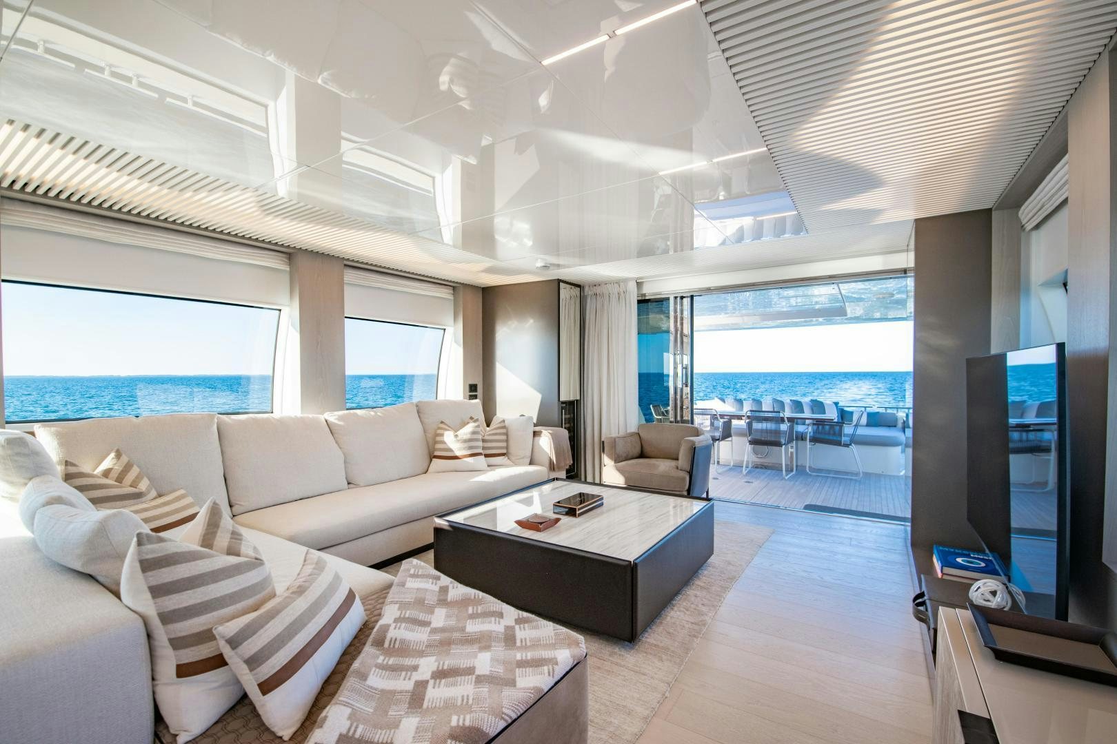 a living room with a large window aboard FERRETTI 850 Yacht for Sale