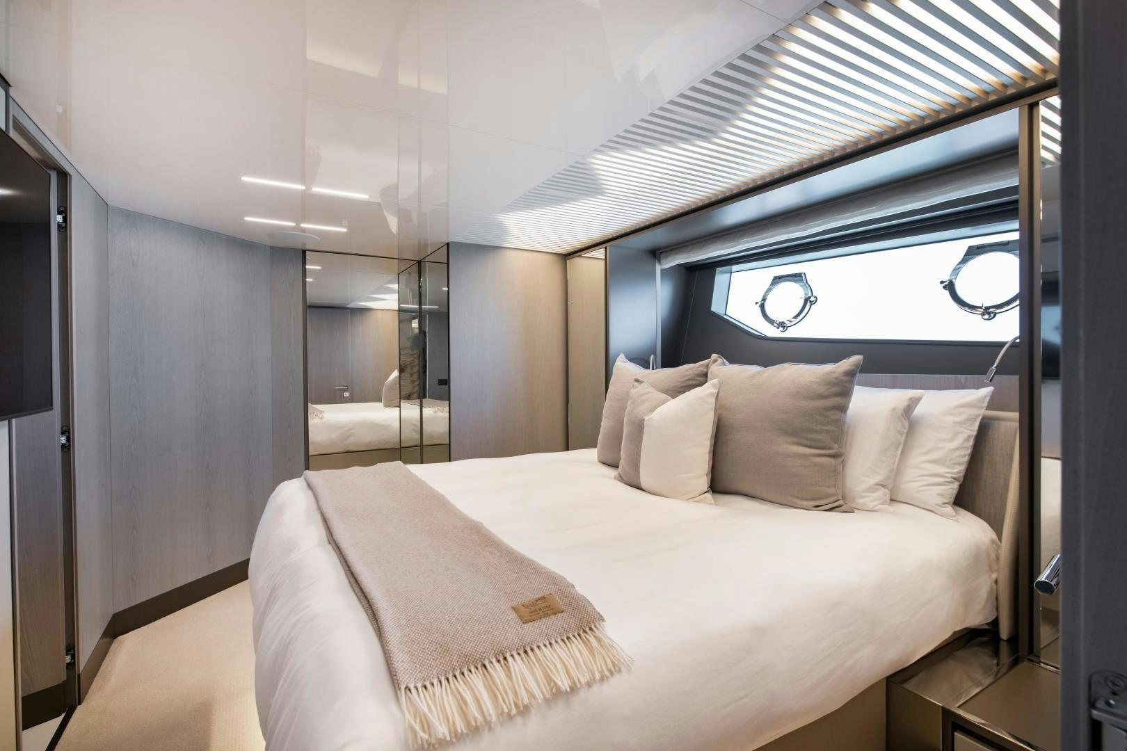 a bed with a white bed spread aboard FERRETTI 850 Yacht for Sale