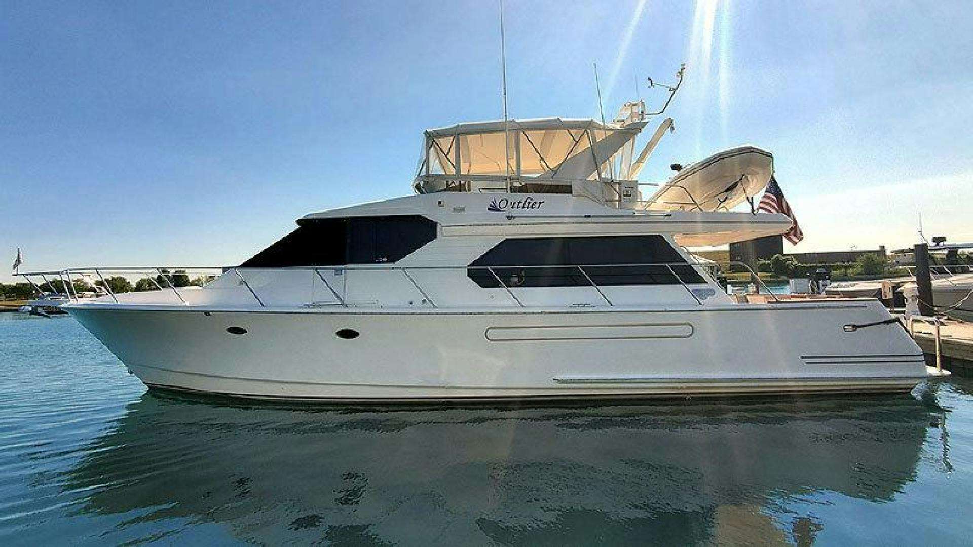 a white yacht in the water aboard OUTLIER Yacht for Sale