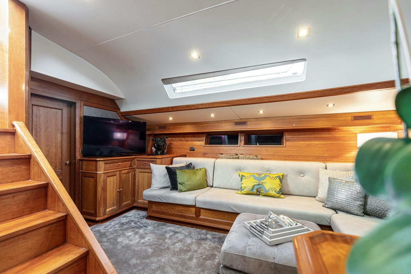 a living room with a couch and a tv aboard FANCY Yacht for Sale