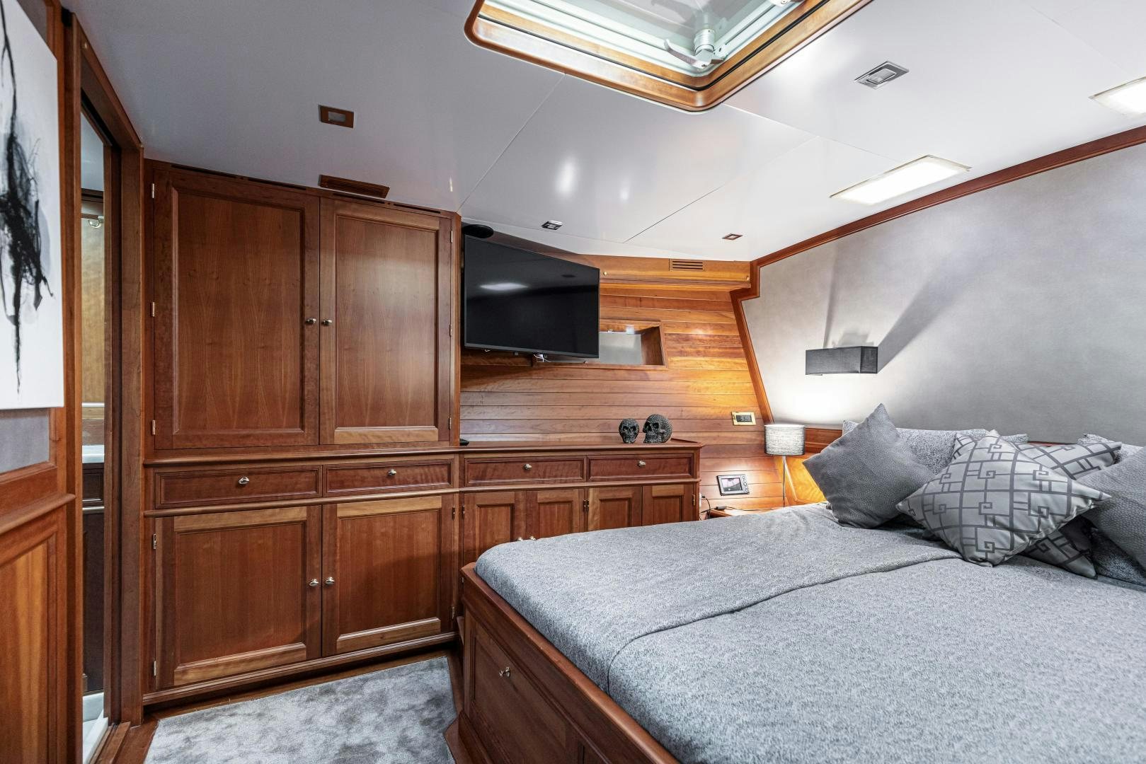 a bedroom with a bed and a television aboard FANCY Yacht for Sale