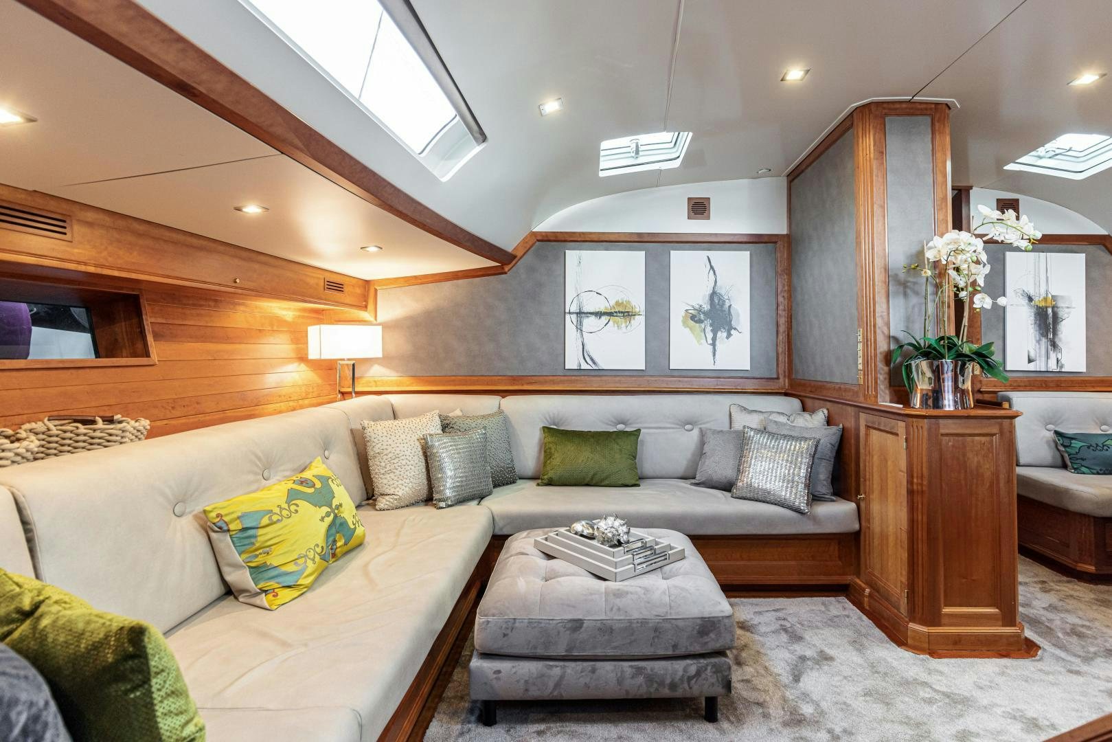 a living room with a couch and a mirror aboard FANCY Yacht for Sale