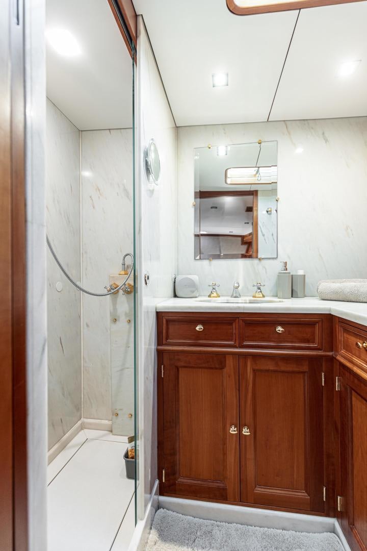 a bathroom with a sink and a mirror aboard FANCY Yacht for Sale