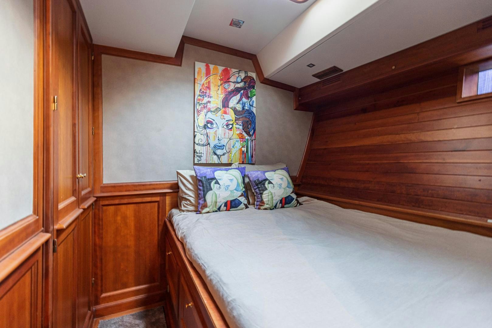 a bedroom with a painting on the wall aboard FANCY Yacht for Sale