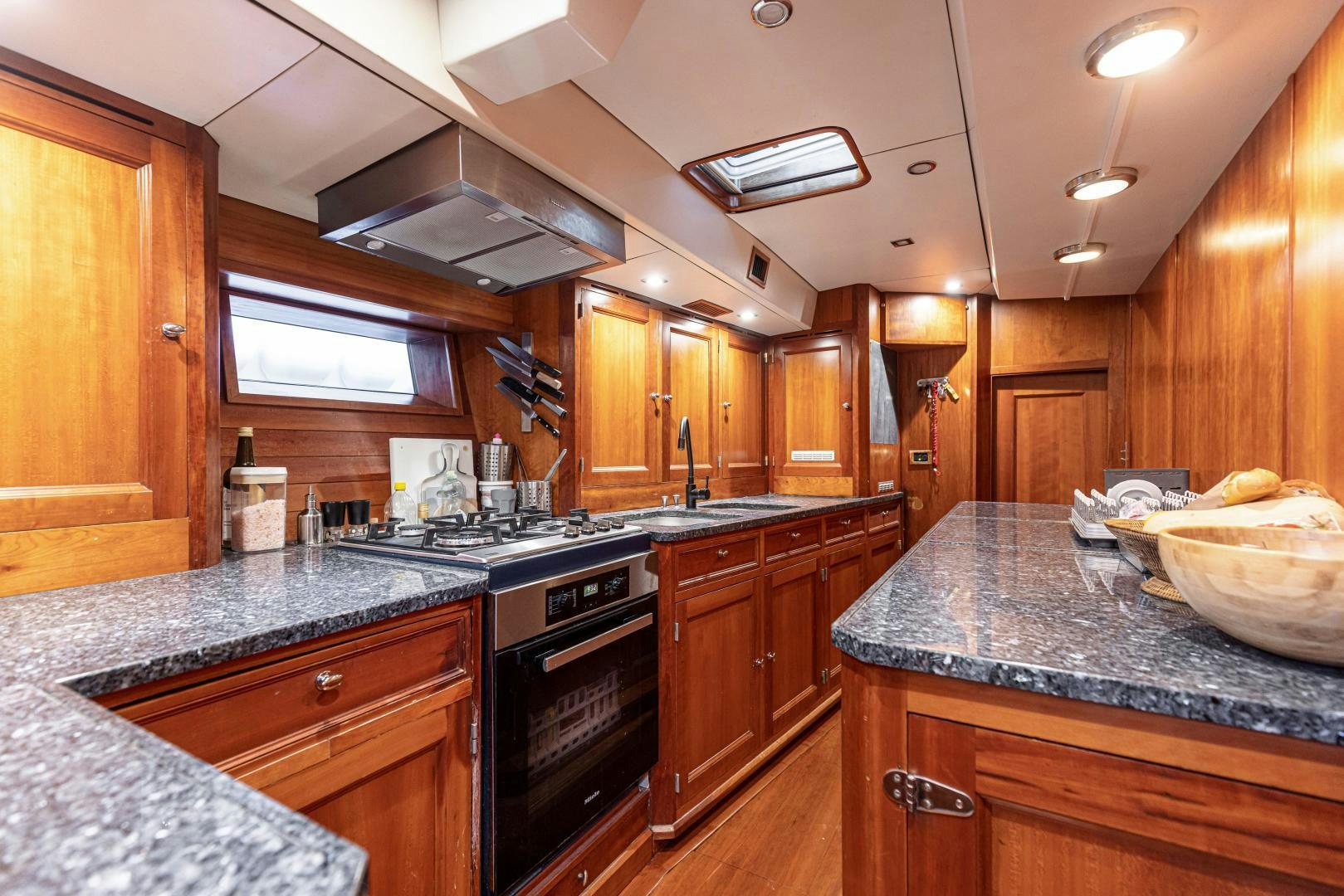 a kitchen with wooden cabinets aboard FANCY Yacht for Sale