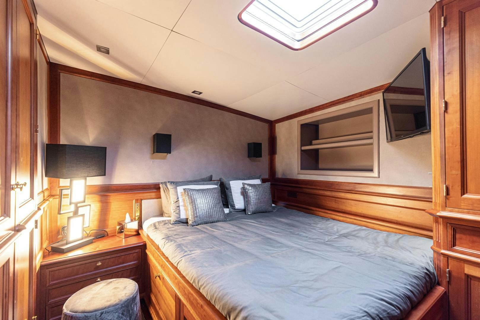 a bedroom with a bed and a television aboard FANCY Yacht for Sale