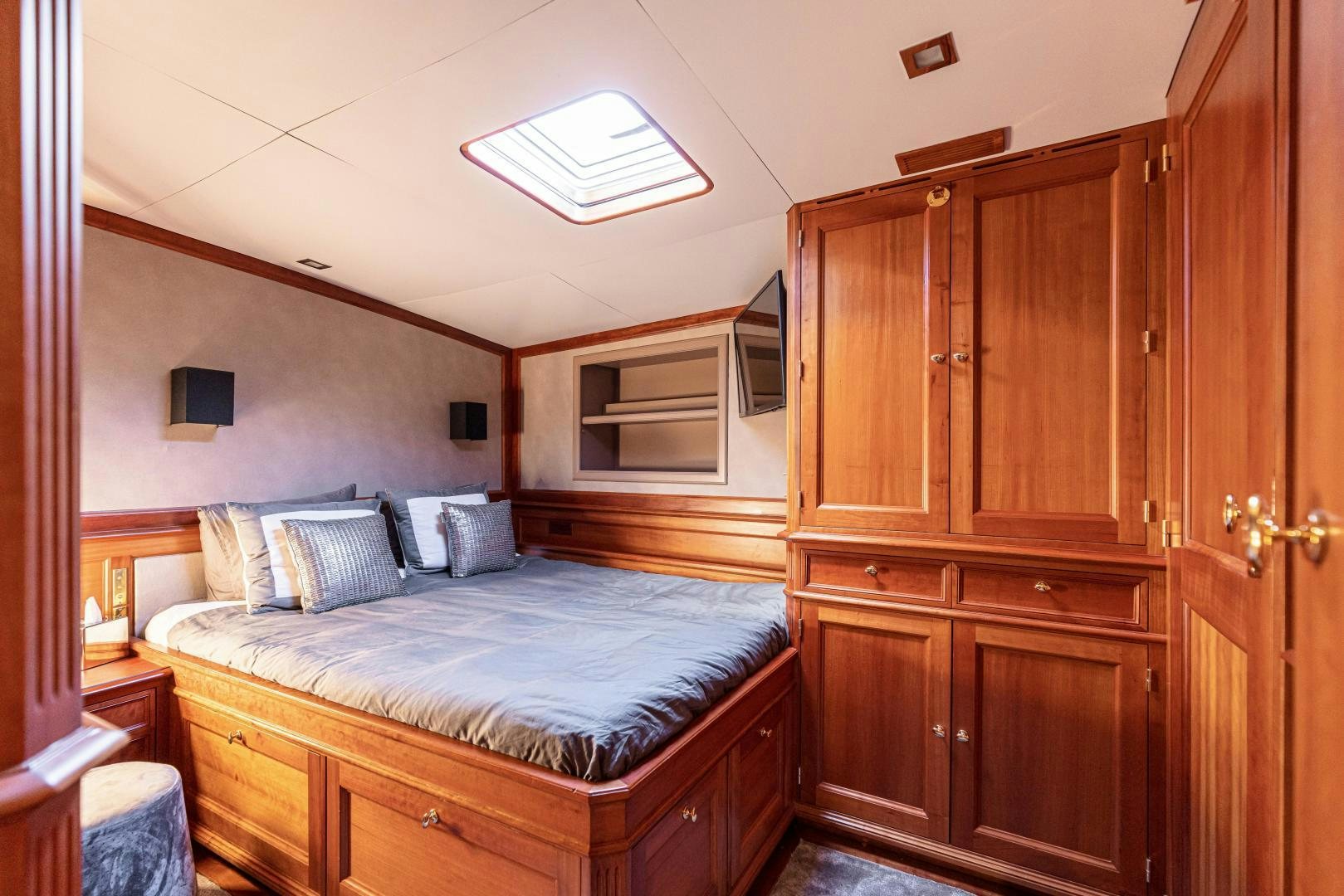 a bedroom with a bed and cabinets aboard FANCY Yacht for Sale