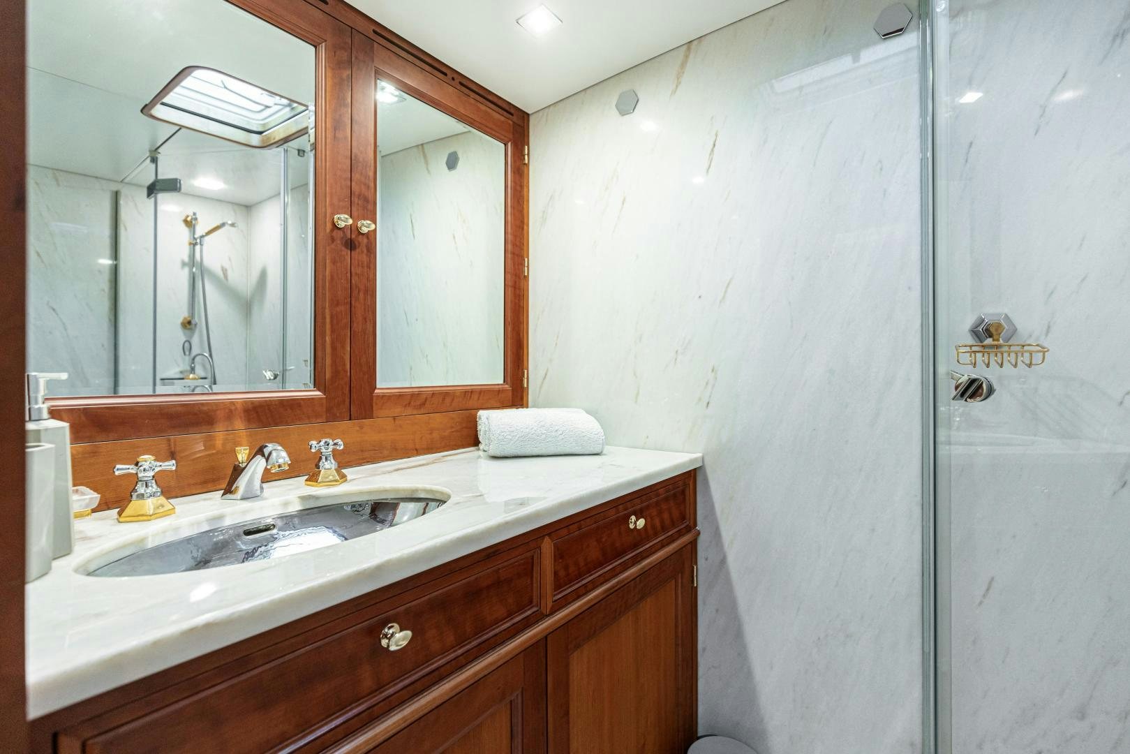 a bathroom with a sink and a mirror aboard FANCY Yacht for Sale