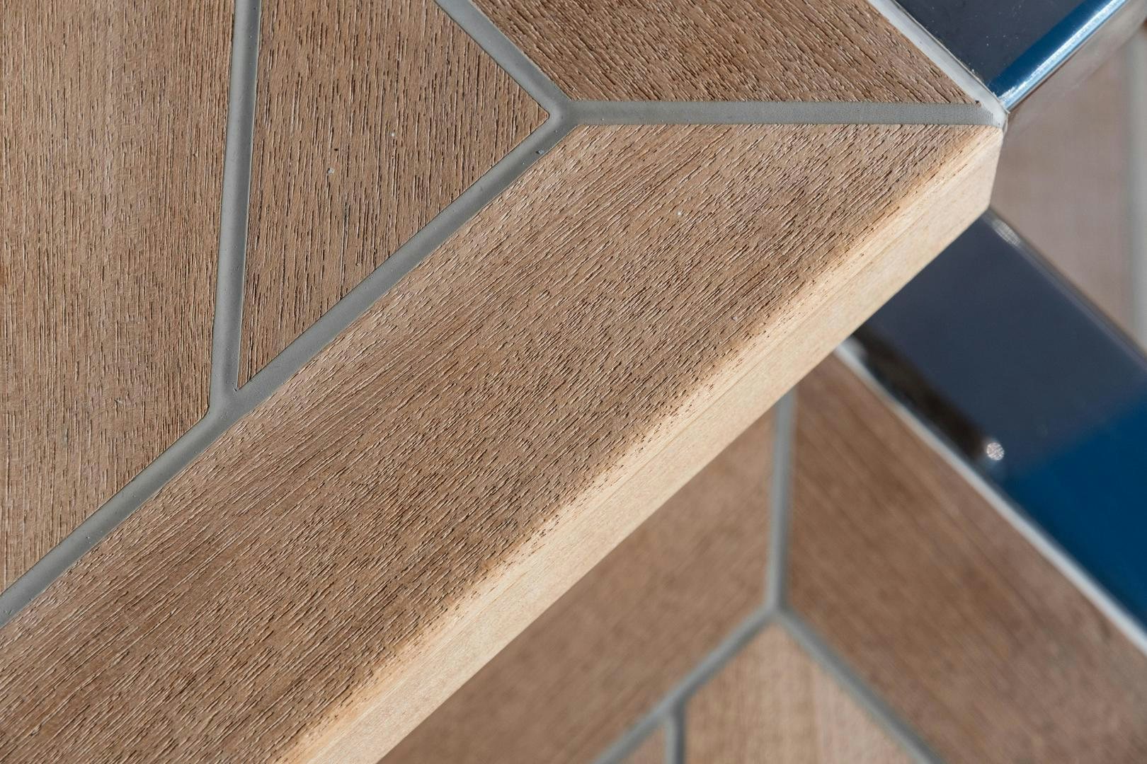 a wooden table with a black object on it aboard EVADNE ROCK 85 HULL 4 Yacht for Sale