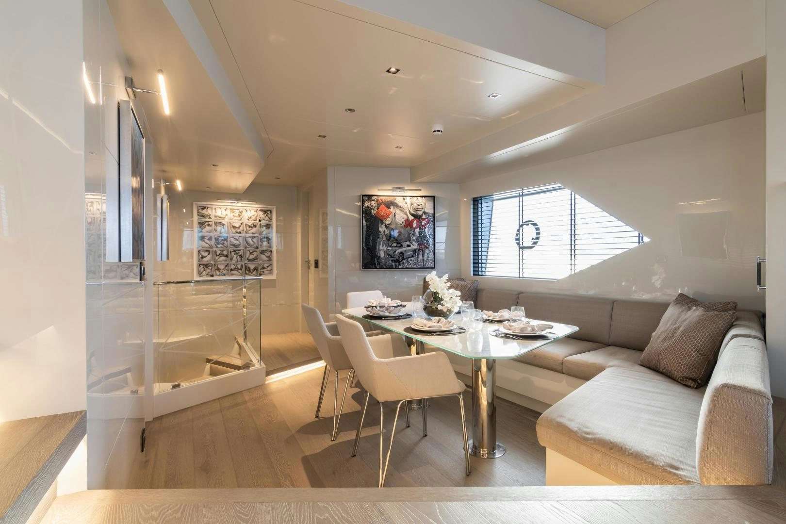 a living room with a table and couches aboard EVADNE ROCK 85 HULL 4 Yacht for Sale
