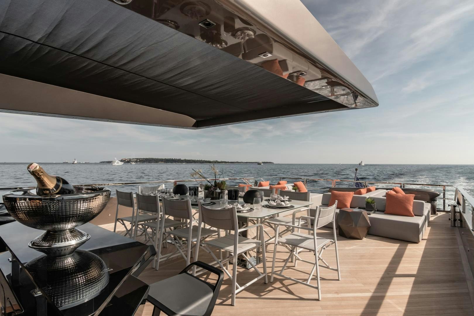 a patio with a table and chairs on it aboard EVADNE ROCK 85 HULL 4 Yacht for Sale