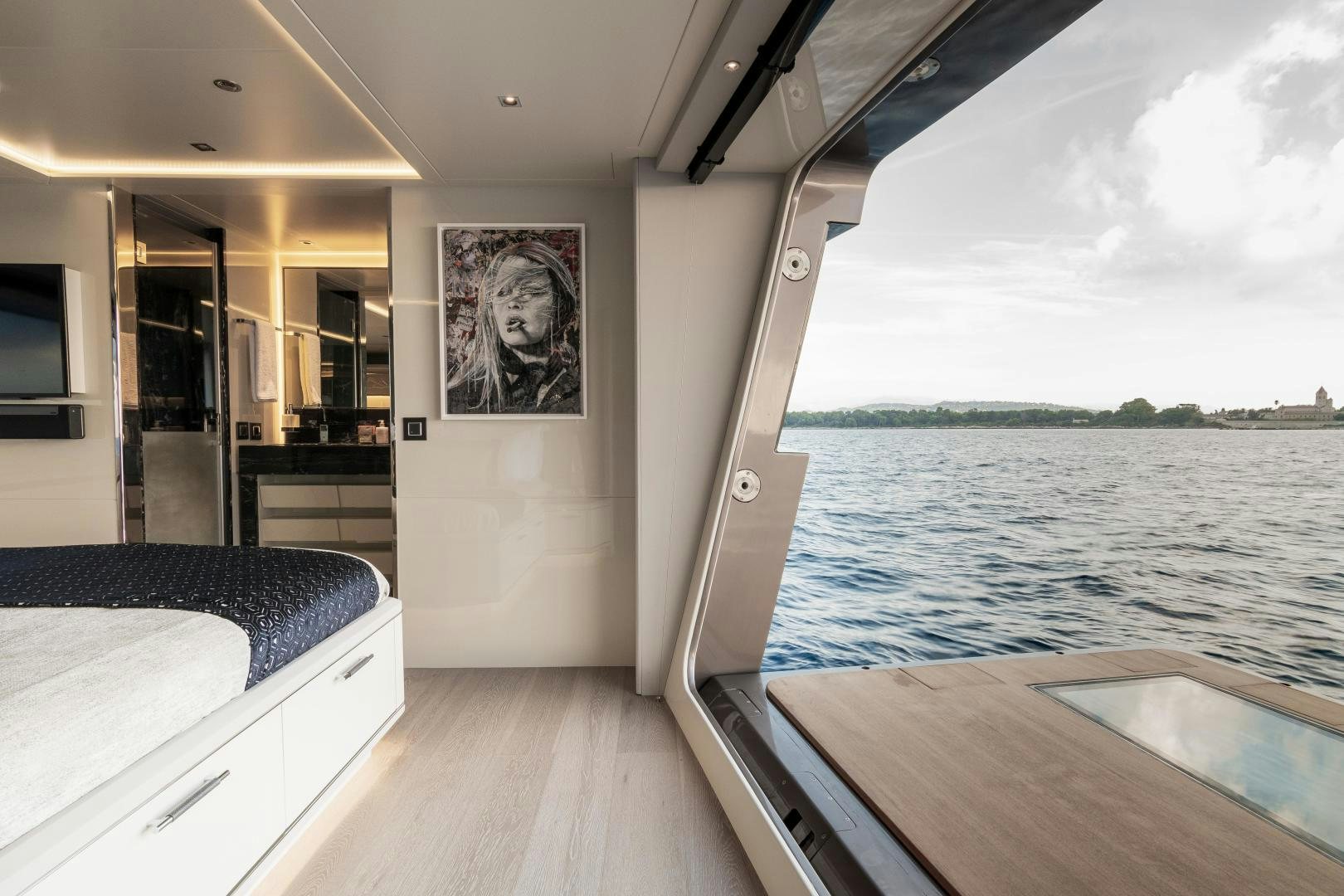 a boat with a table and a bed in it aboard EVADNE ROCK 85 HULL 4 Yacht for Sale