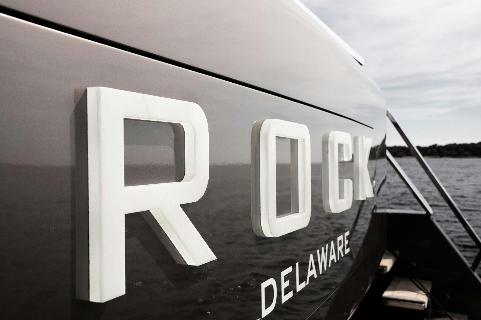 a white letter on a black surface aboard EVADNE ROCK 85 HULL 4 Yacht for Sale