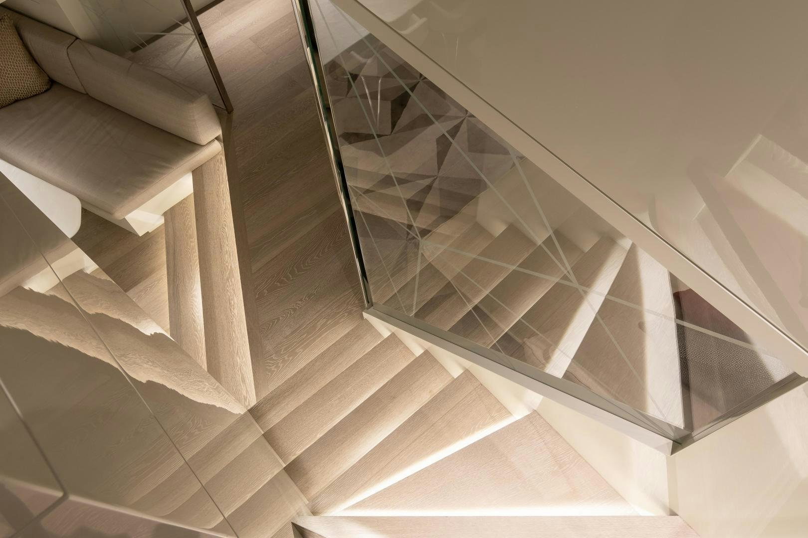 a staircase with a glass railing aboard EVADNE ROCK 85 HULL 4 Yacht for Sale