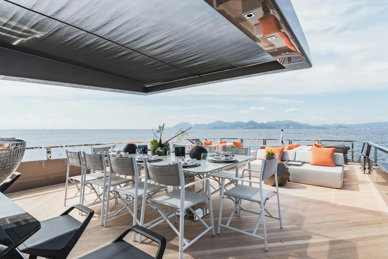 a patio with a table and chairs aboard EVADNE ROCK 85 HULL 4 Yacht for Sale