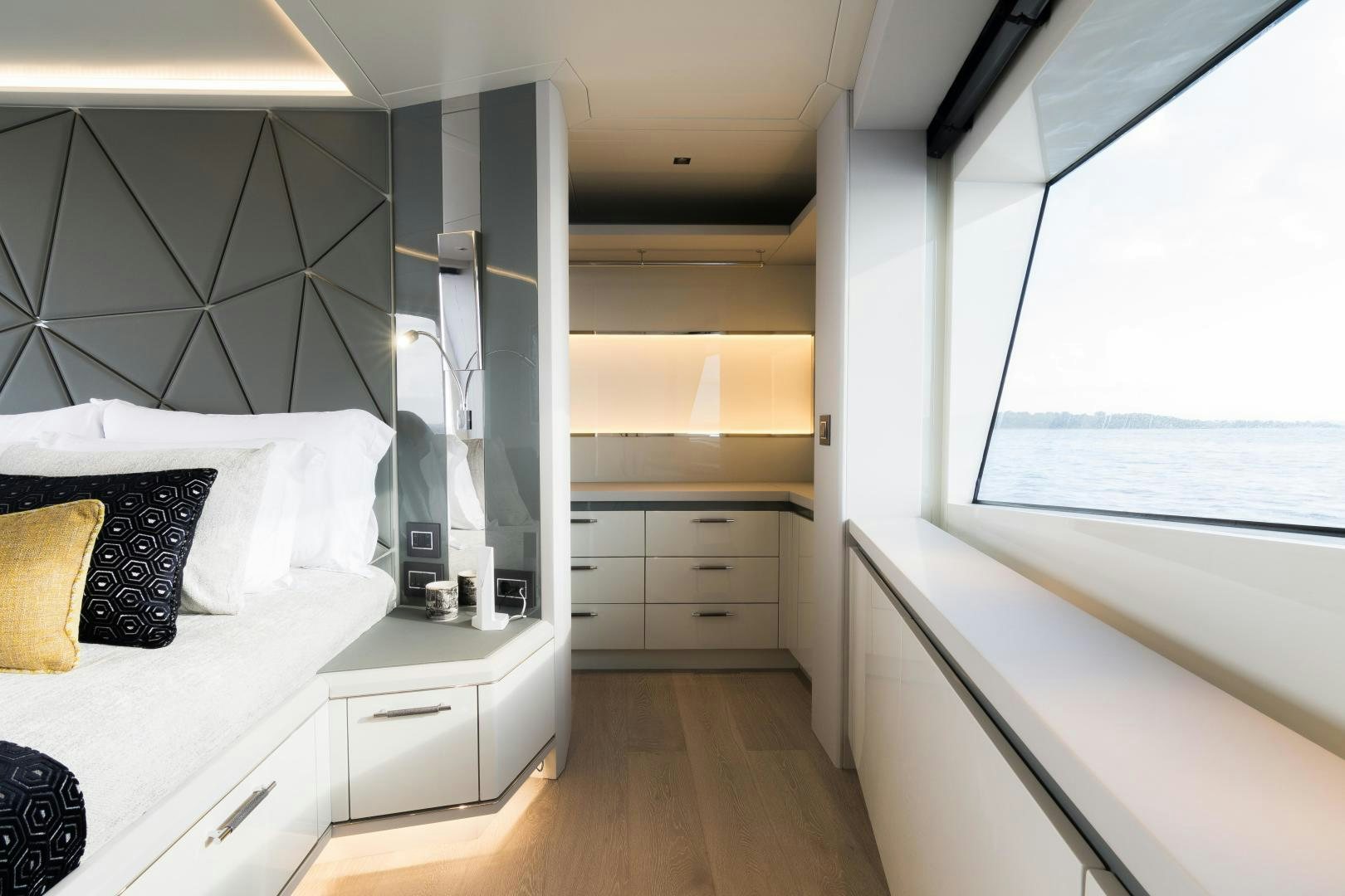 a bedroom with a bed and a window aboard EVADNE ROCK 85 HULL 4 Yacht for Sale
