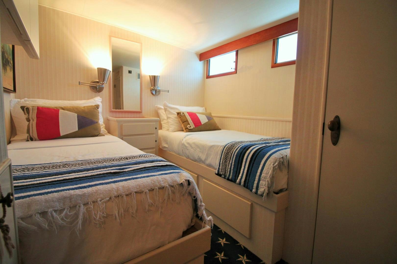 a couple of beds in a room aboard Independence Yacht for Sale