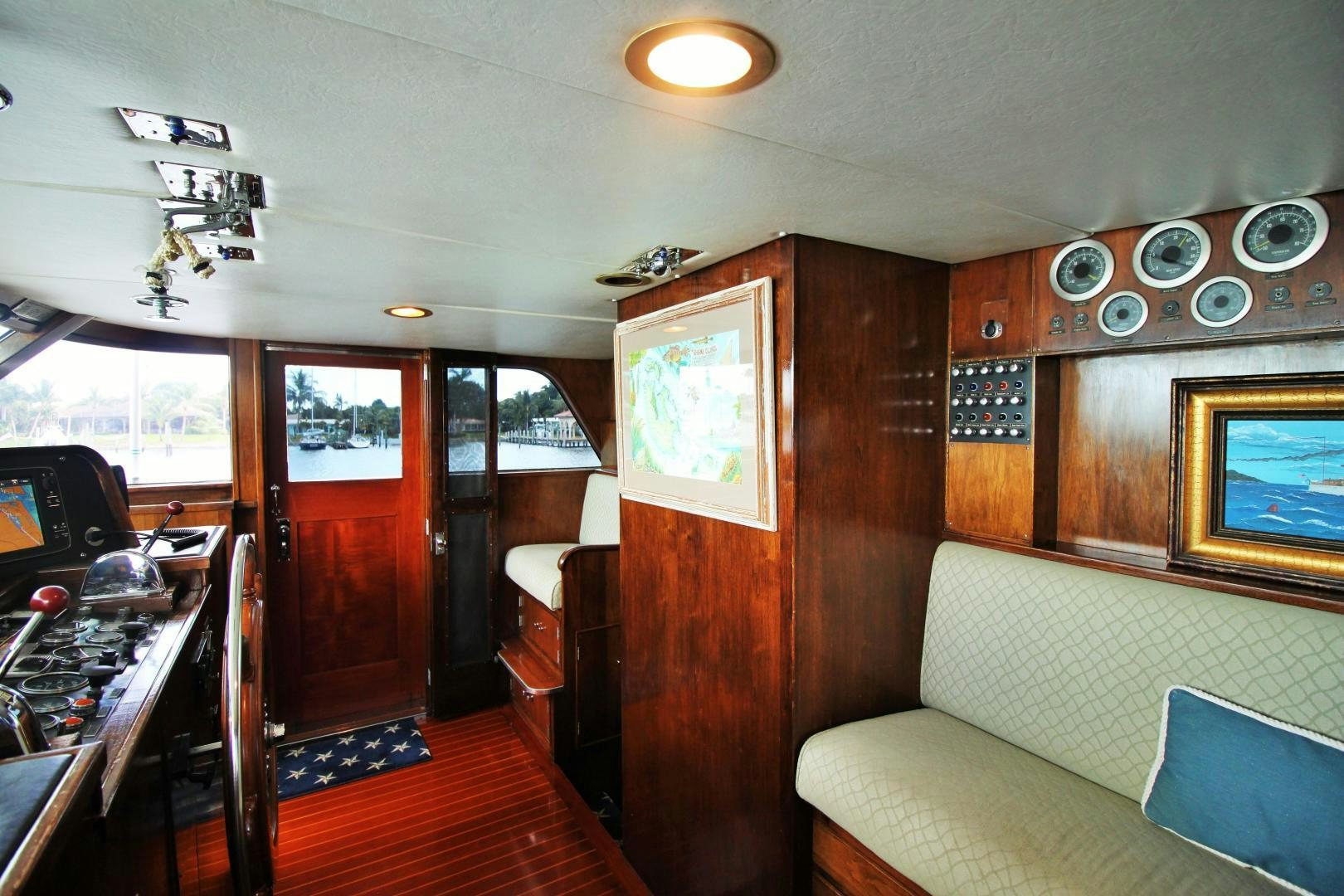 a room with a bed and a couch aboard Independence Yacht for Sale
