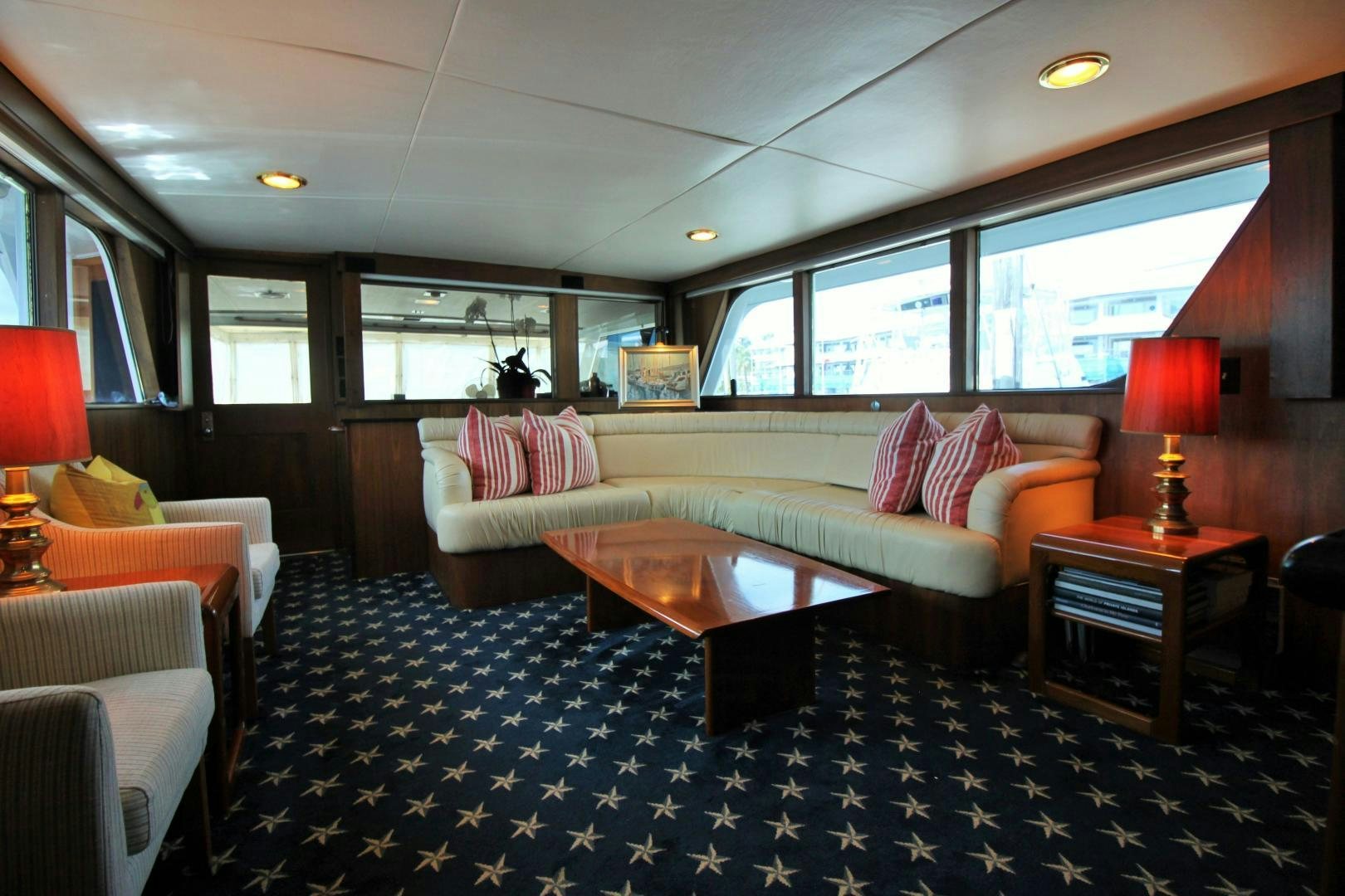 a living room with a couch and a table aboard Independence Yacht for Sale