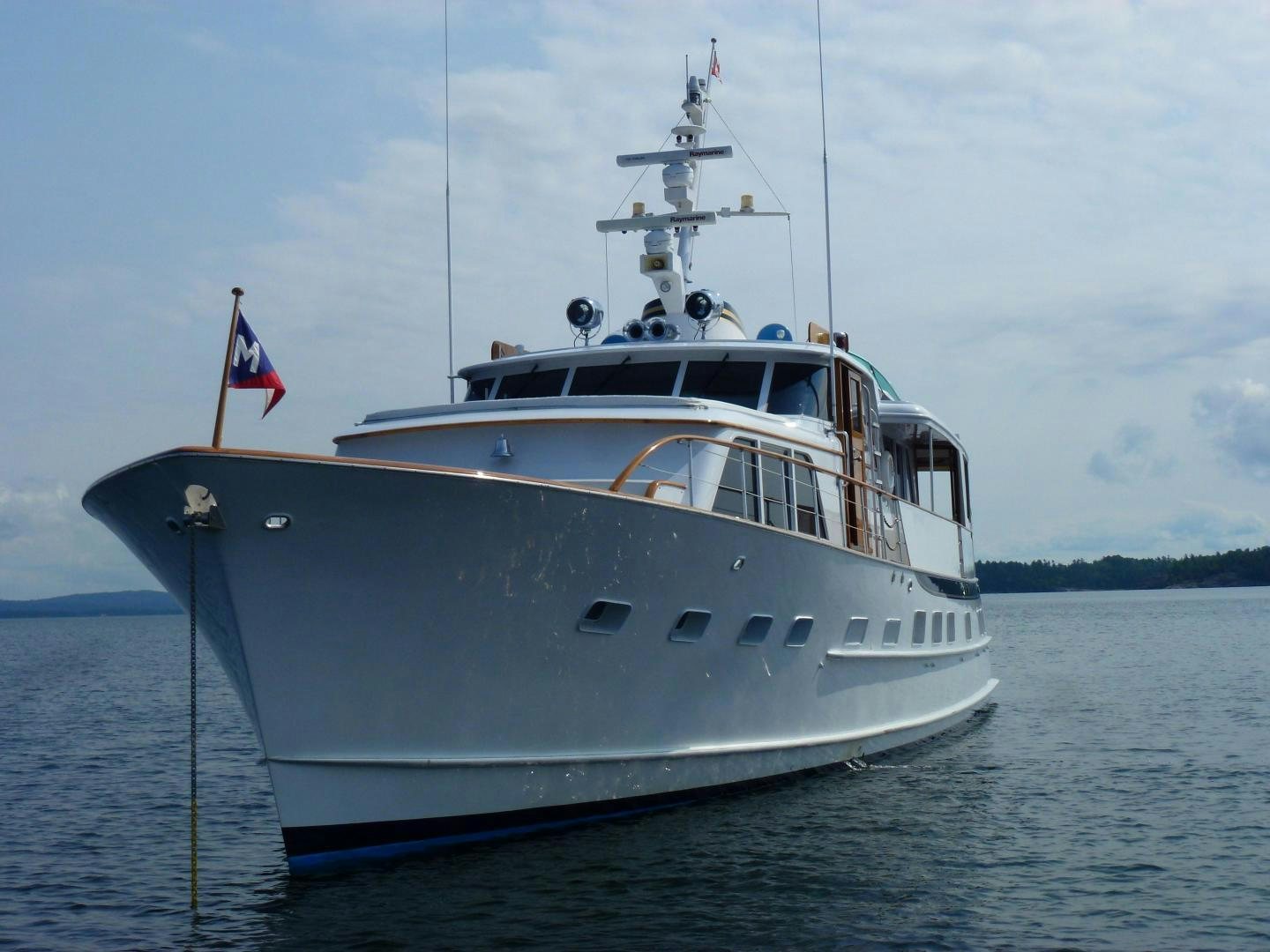 a large boat on the water aboard Independence Yacht for Sale