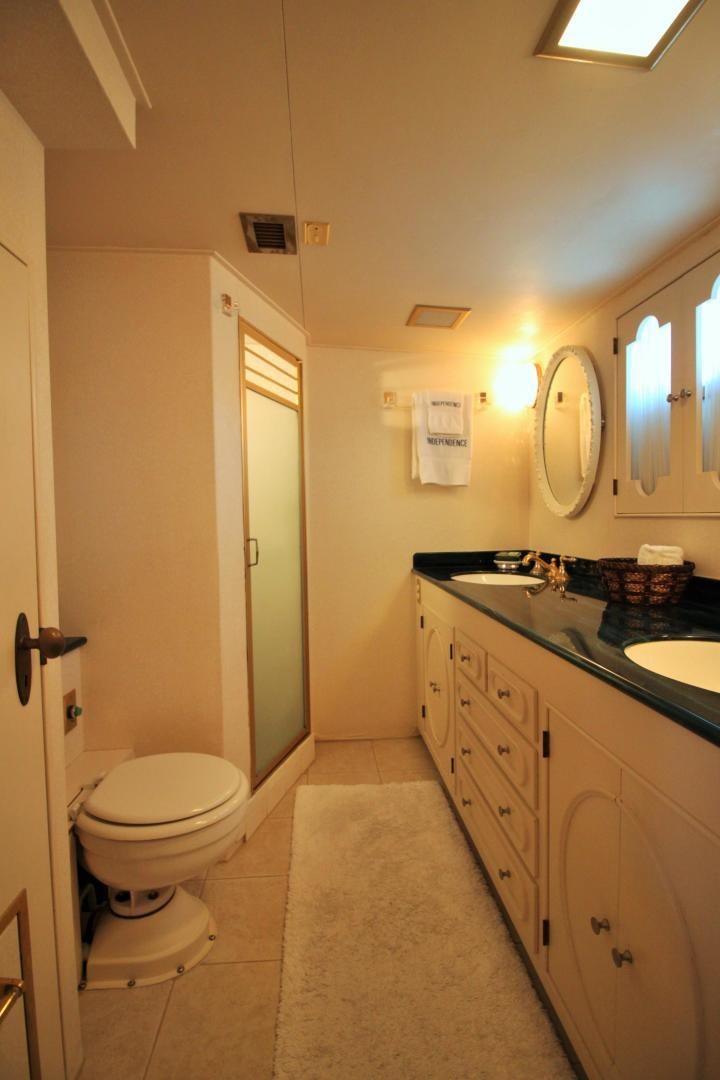 a bathroom with a toilet and a sink aboard Independence Yacht for Sale