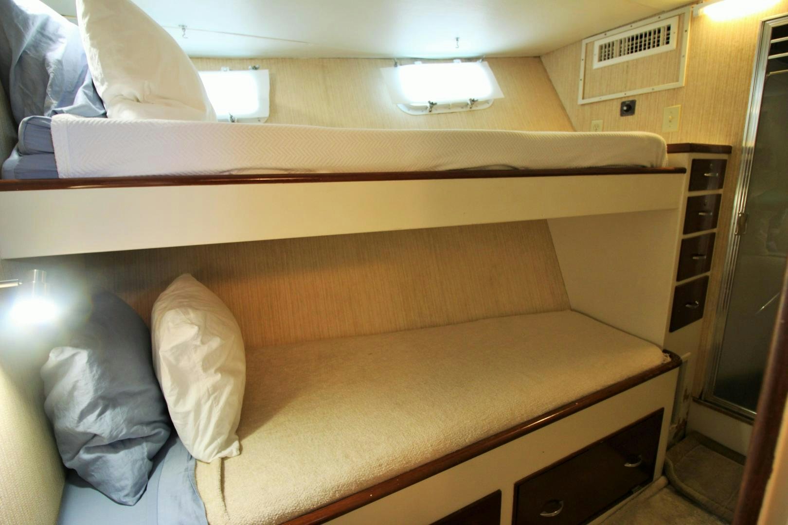 a bed with a white pillow aboard Independence Yacht for Sale