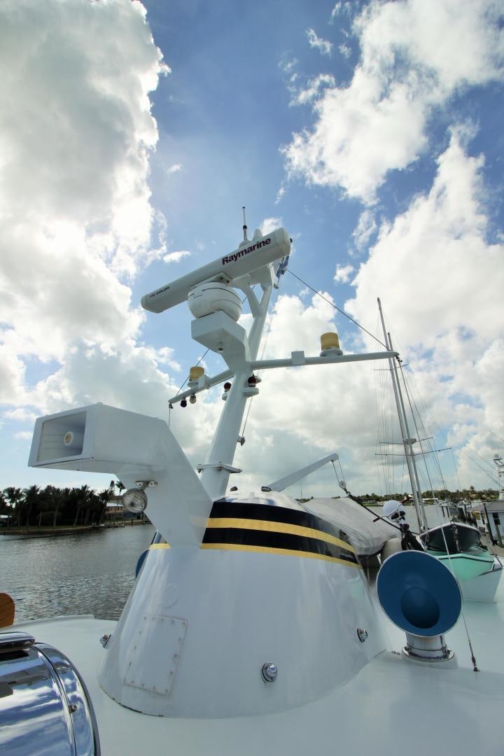a large white boat with a large antenna on it aboard Independence Yacht for Sale