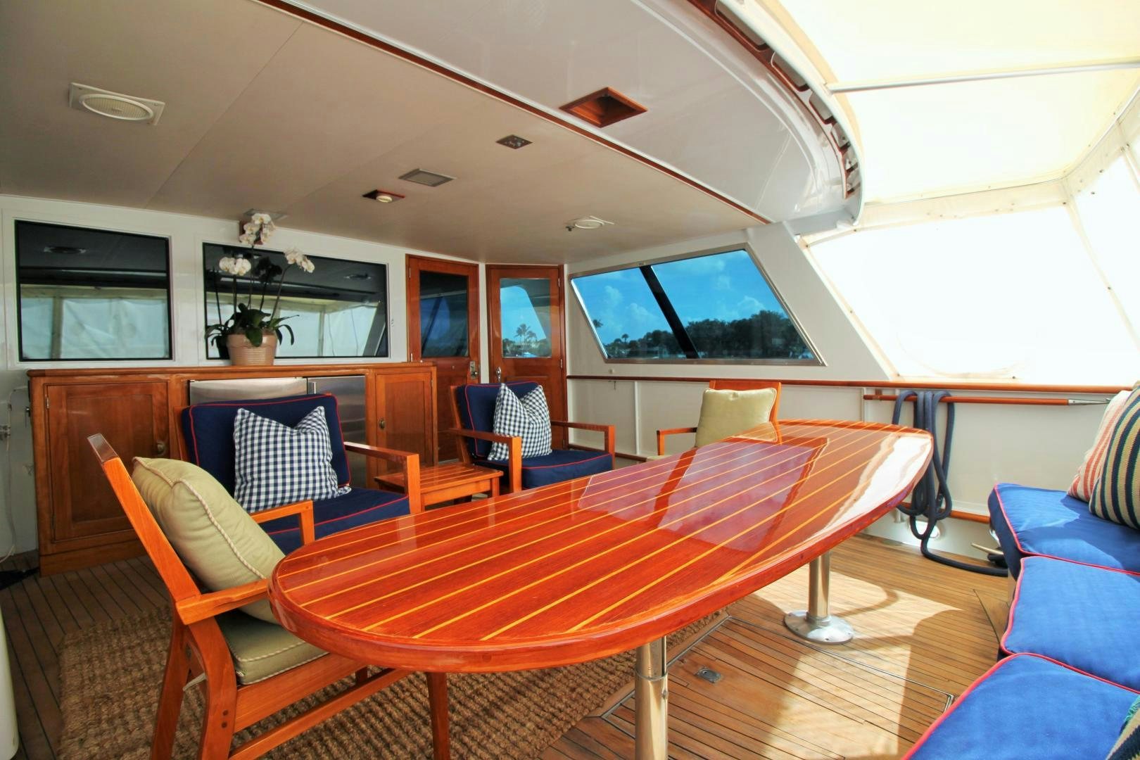 a room with a table and chairs aboard Independence Yacht for Sale