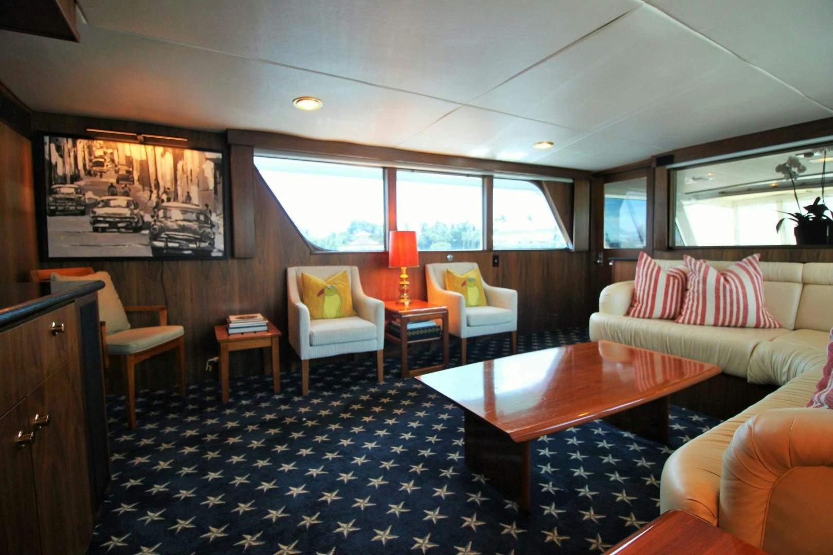 a living room with a blue rug aboard Independence Yacht for Sale