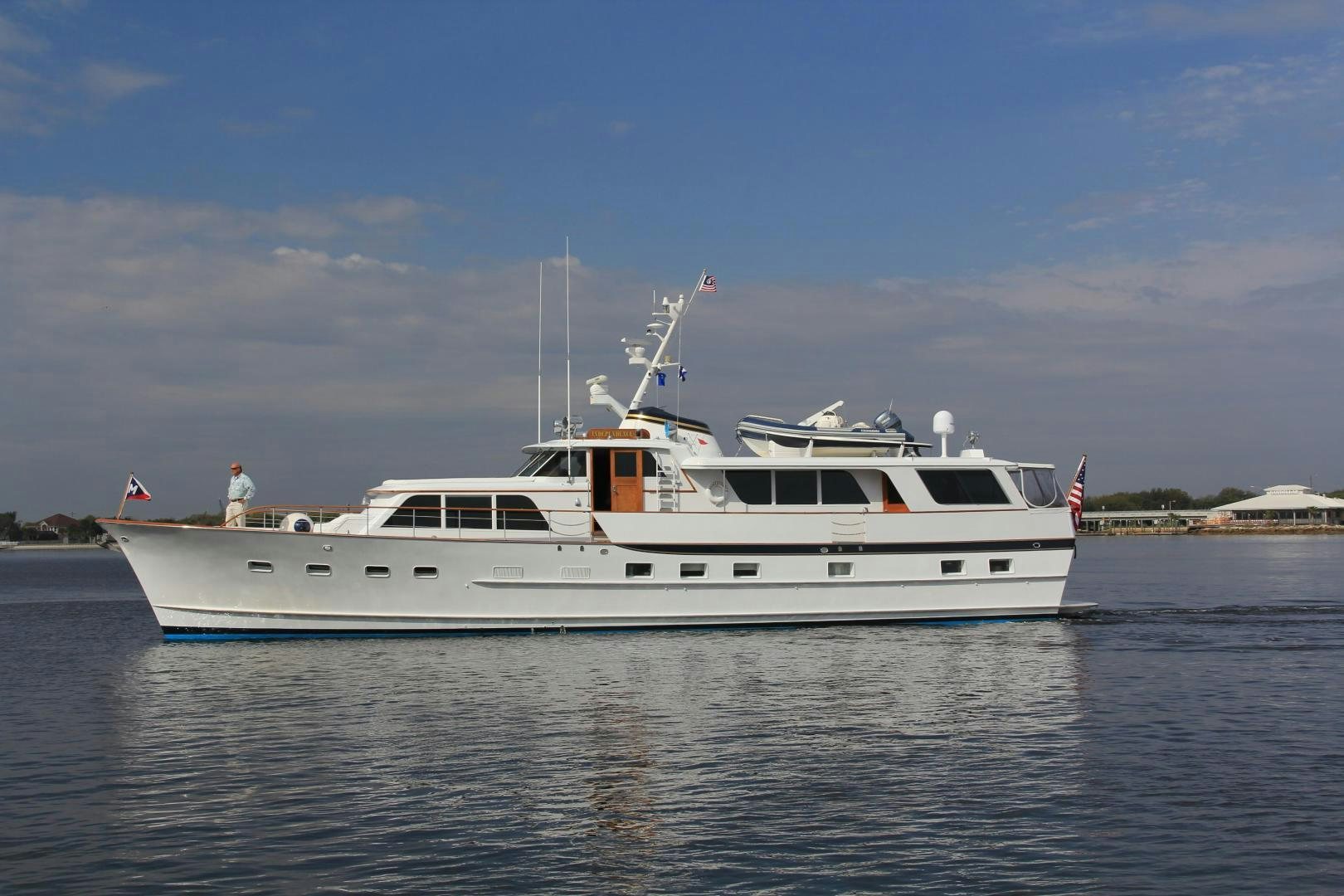 a white boat on the water aboard Independence Yacht for Sale