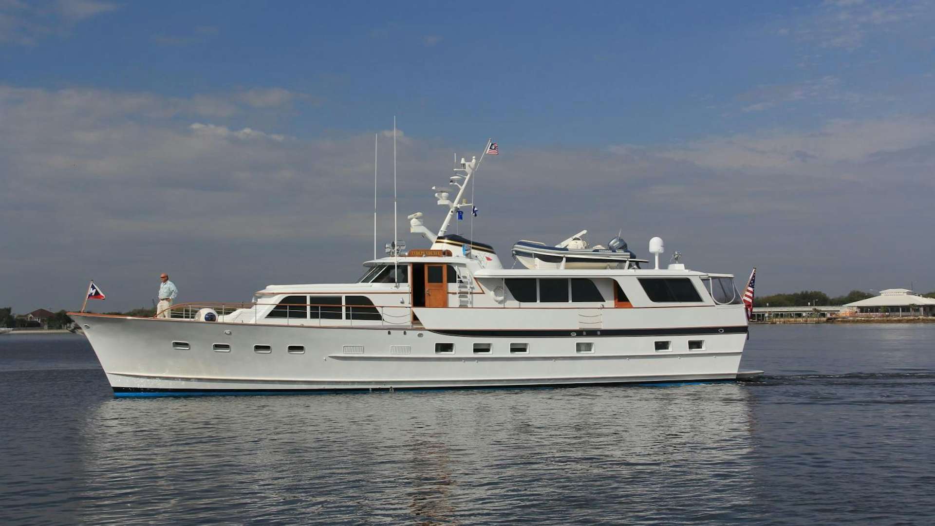a white boat on the water aboard Independence Yacht for Sale