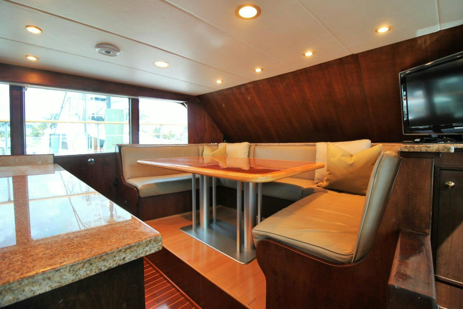 a living room with a table and couches aboard Independence Yacht for Sale