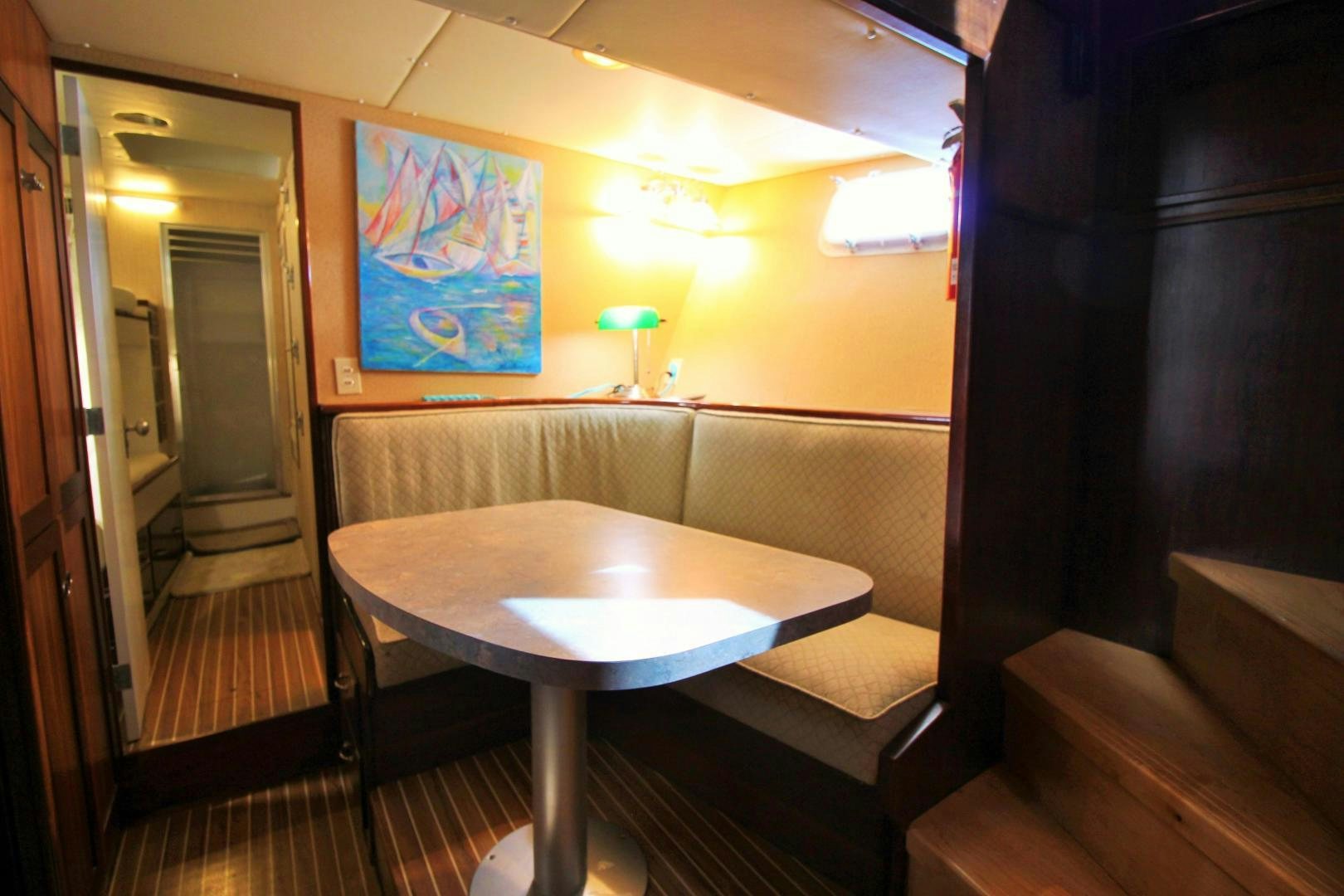 a table and a bench in a room aboard Independence Yacht for Sale