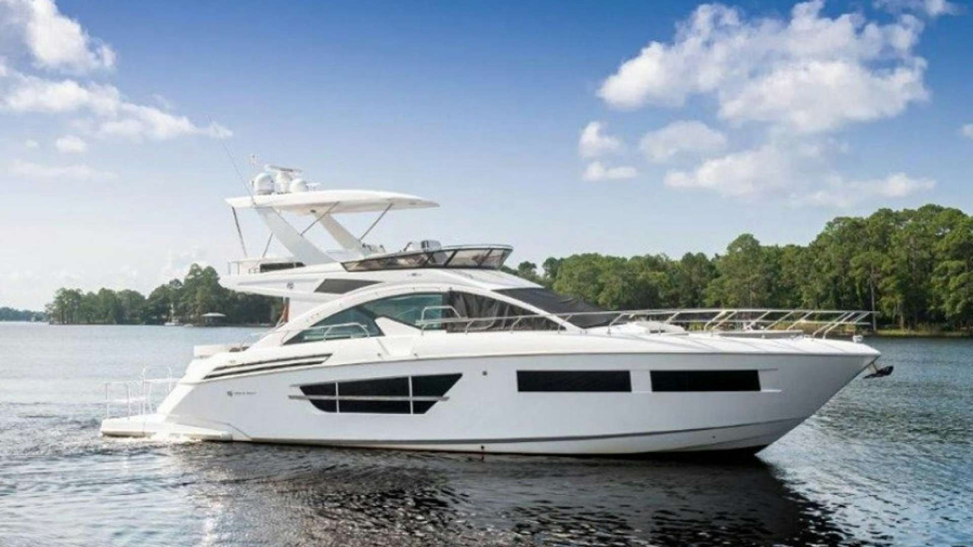 a white yacht on the water aboard OMG Yacht for Sale