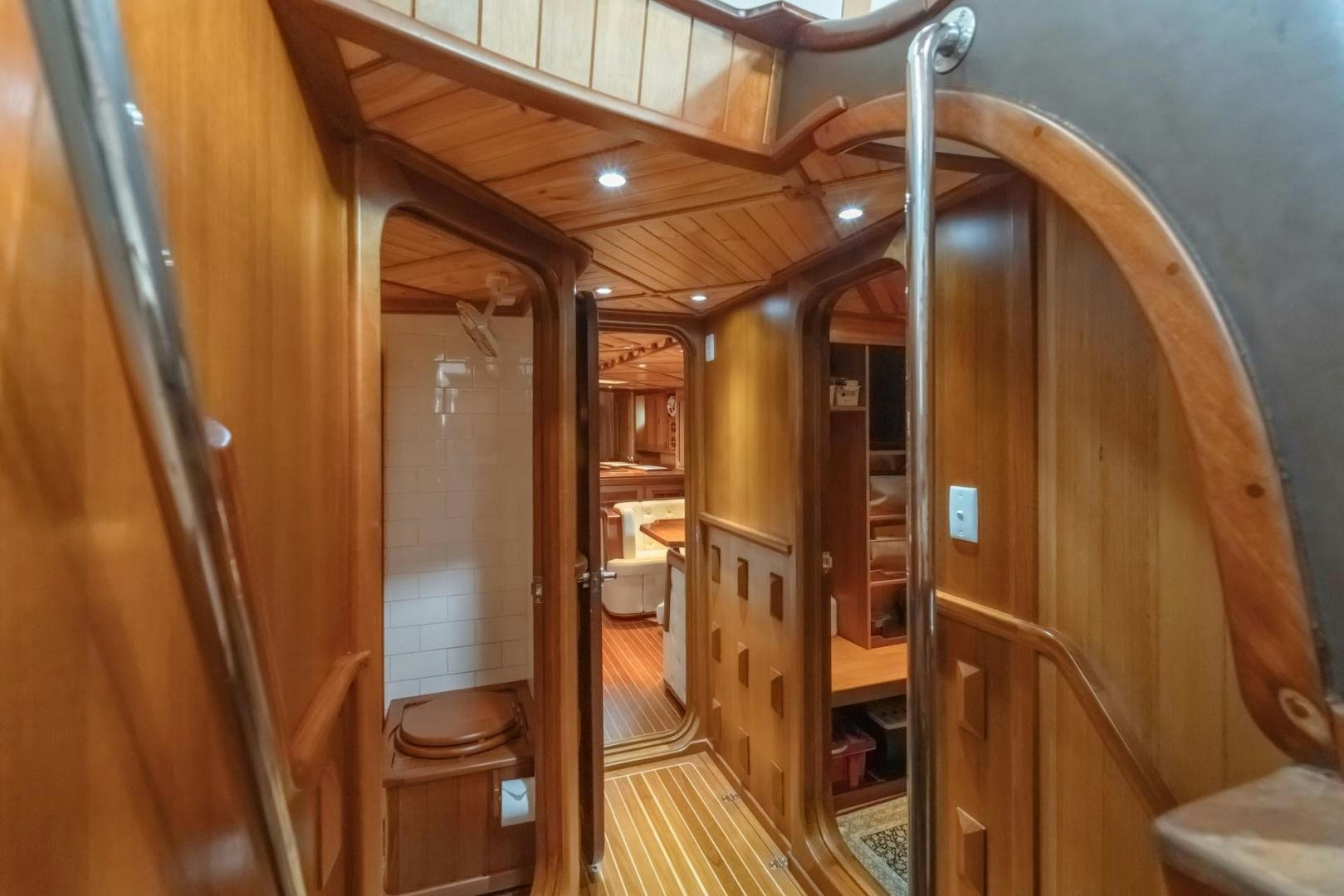 a hallway with wood walls aboard FIREBIRD Yacht for Sale