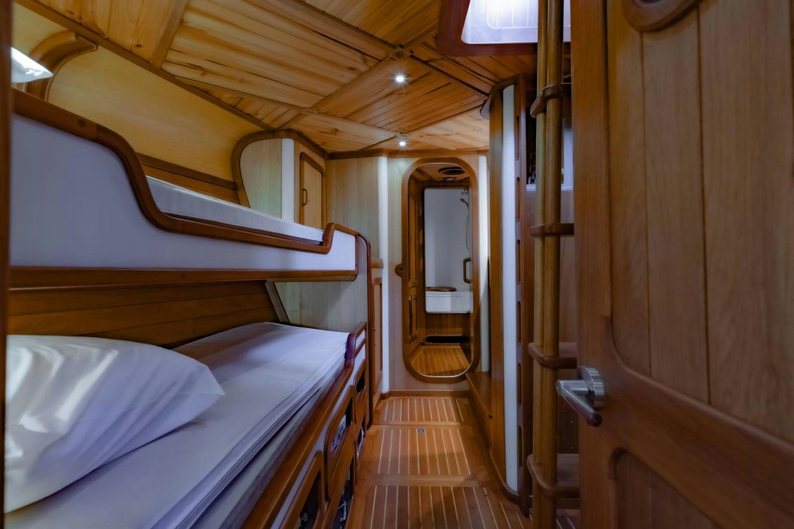 a cabin with a bed aboard FIREBIRD Yacht for Sale