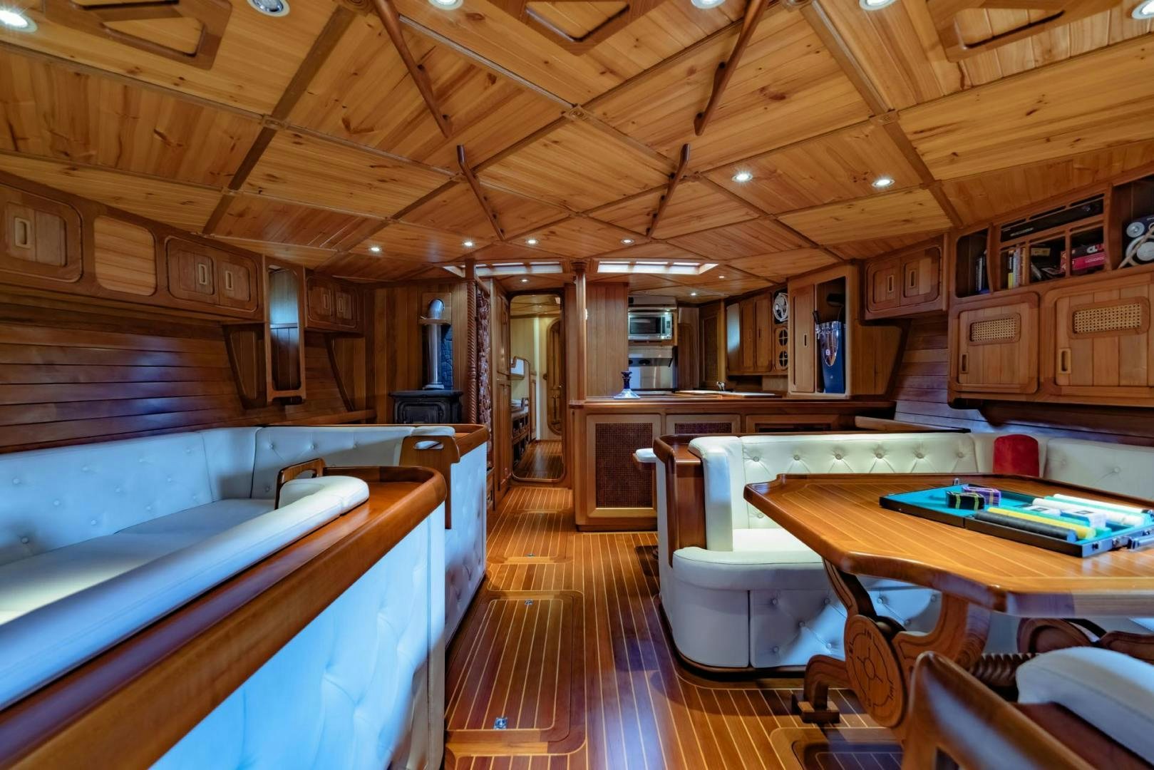 a large kitchen with a pool table aboard FIREBIRD Yacht for Sale