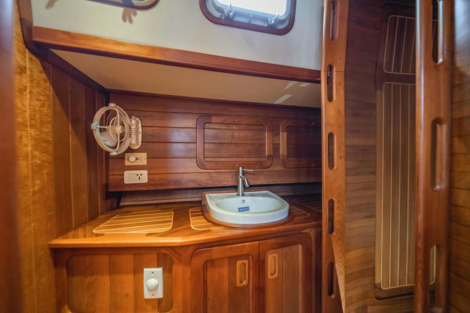 a kitchen with wooden cabinets aboard FIREBIRD Yacht for Sale
