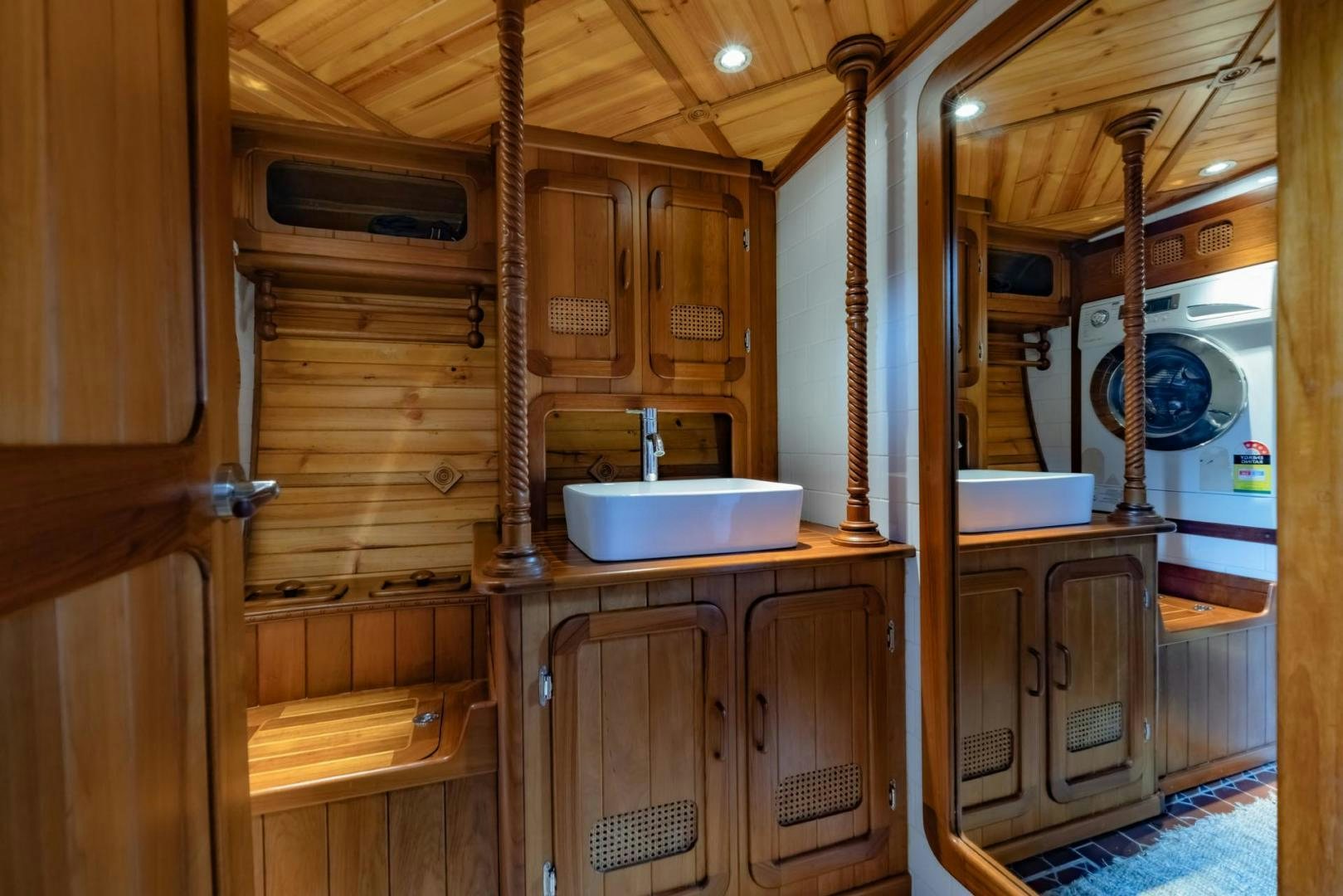 a wooden kitchen with wooden cabinets aboard FIREBIRD Yacht for Sale