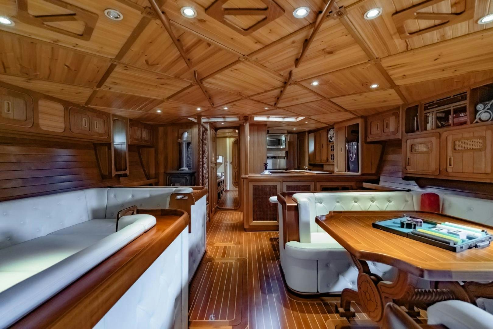 a kitchen with wooden cabinets aboard FIREBIRD Yacht for Sale