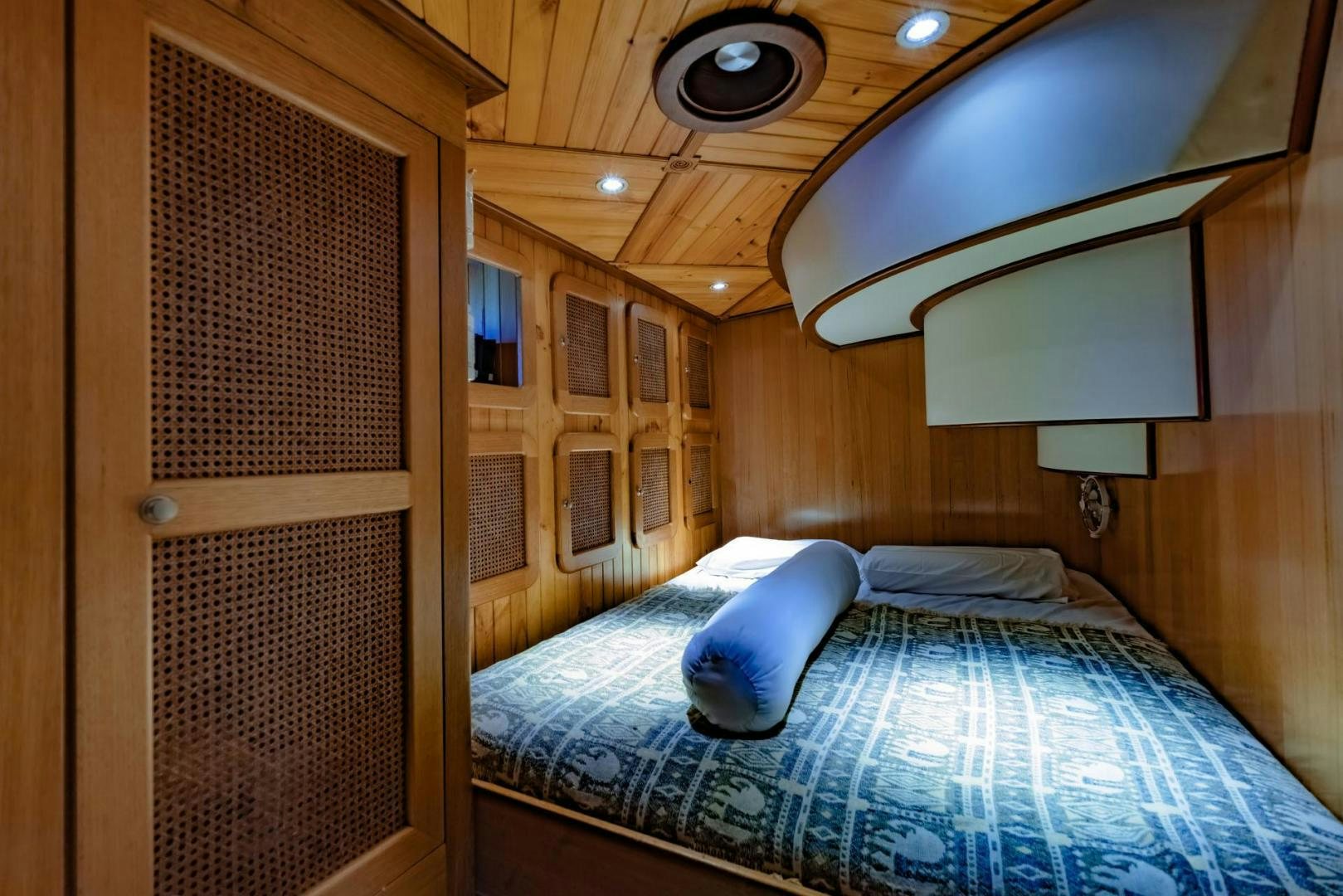 a bed with blue sheets aboard FIREBIRD Yacht for Sale