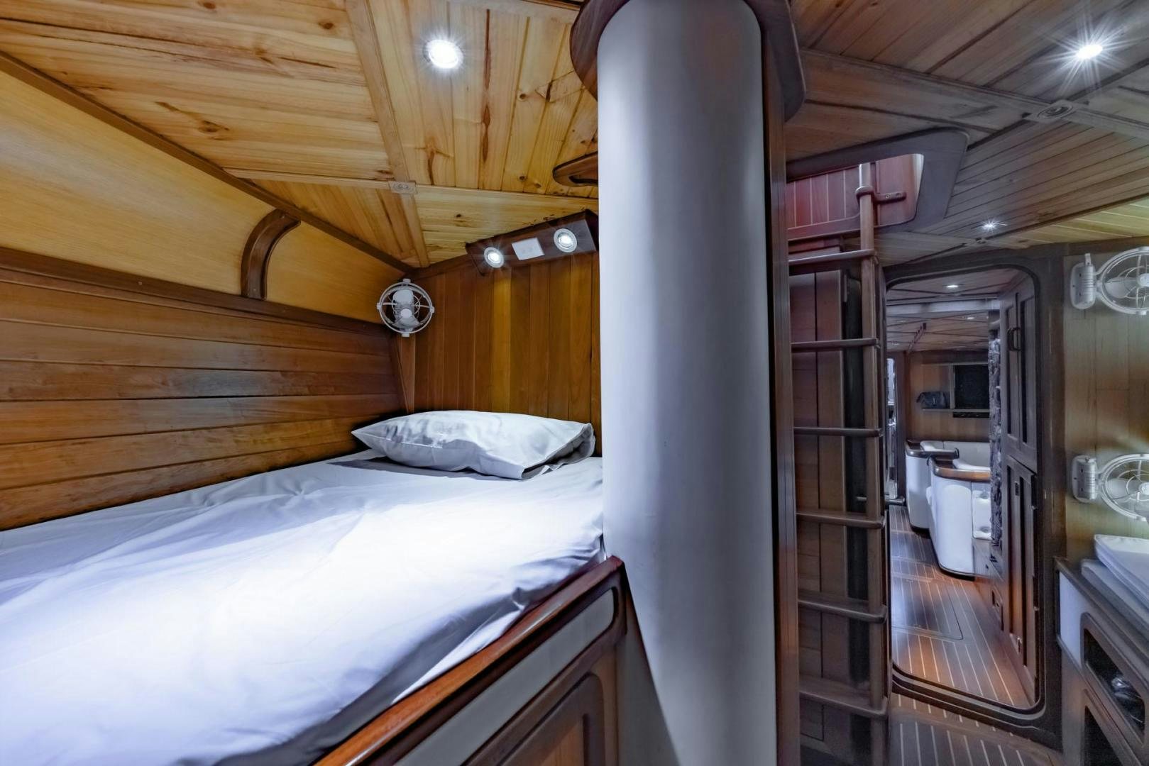 a bedroom with a bed and a mirror aboard FIREBIRD Yacht for Sale